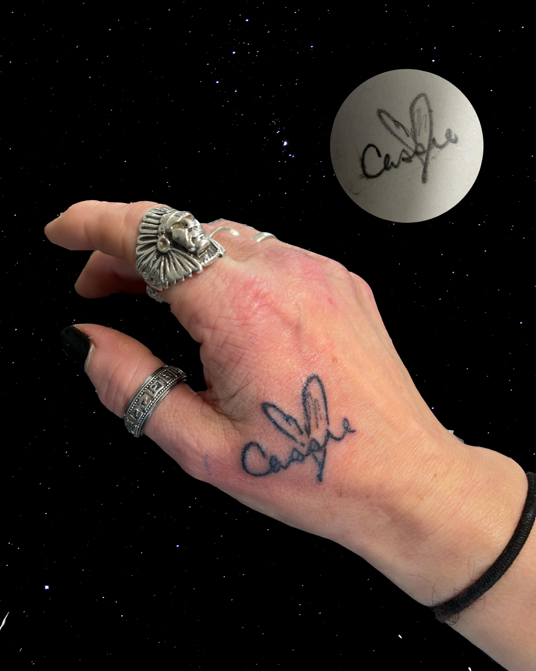 Close-up of a hand with a Hand Poke Tattoo of handwritting reading "Cassie" with an inset of the original signed paper 