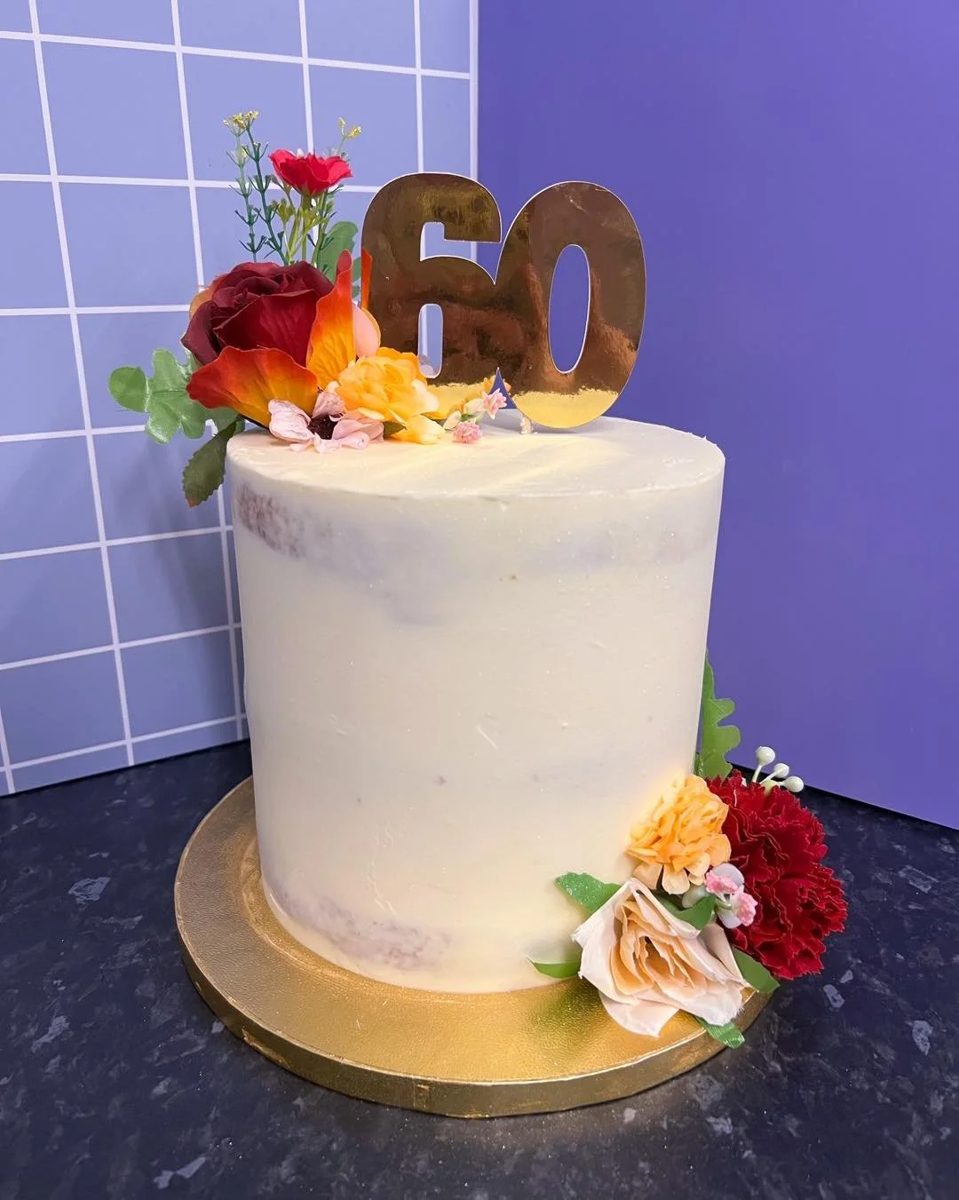 60th birthday cake 🎂 decorated in a semi naked finish, with faux flowers and a number topper ✨
A recreation of a previous cake I&rsquo;ve made, with different coloured flowers 🥰 

#bakewithlil #baking #wiltshirebakes #cakesofinstagram #cakedecorati