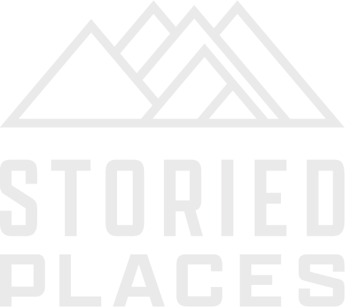 Logo with mountain peaks above the text "STORIED PLACES" in bold, uppercase letters.