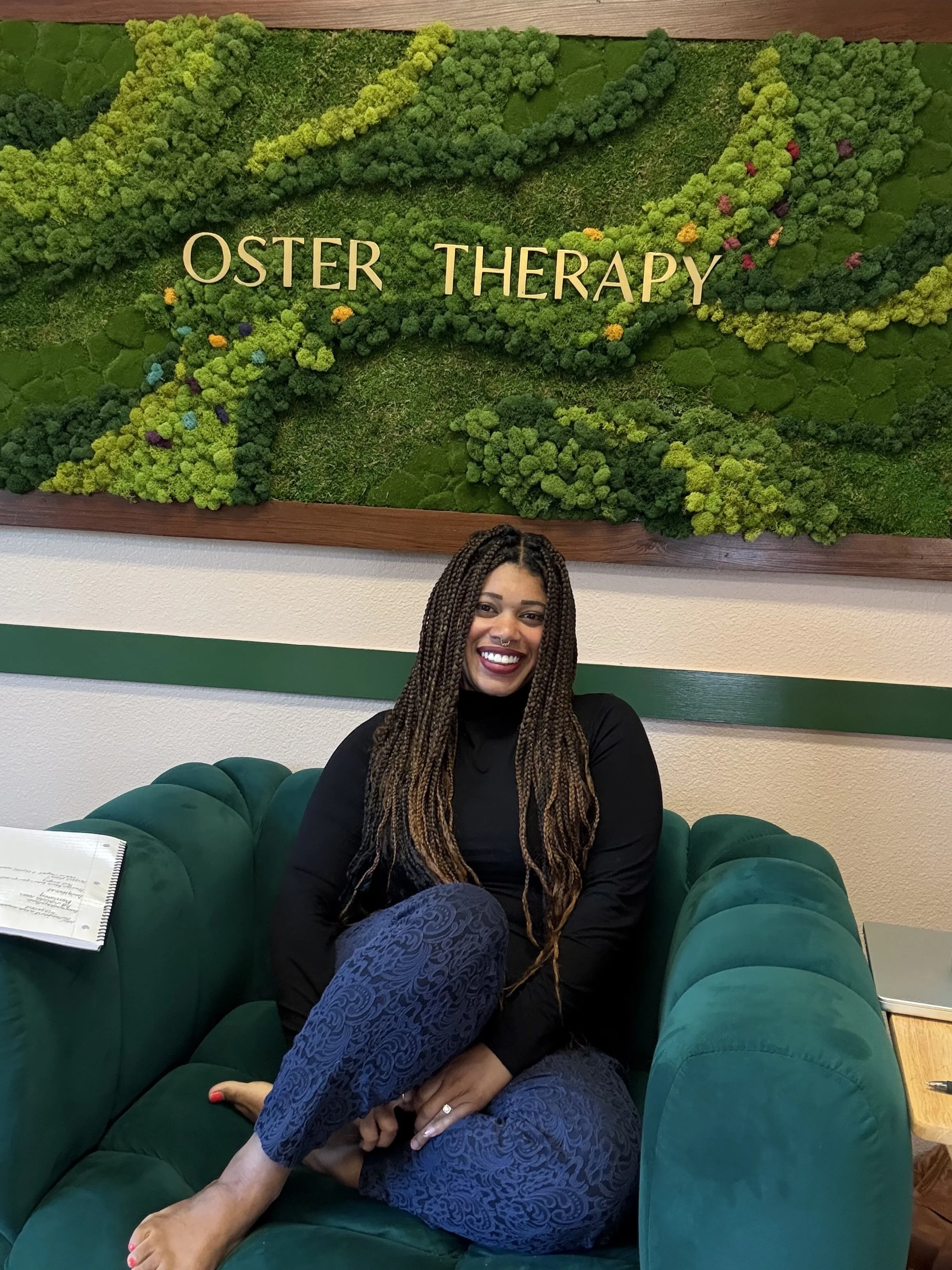 Dominique Oster, Sex Therapist, sitting on green chair