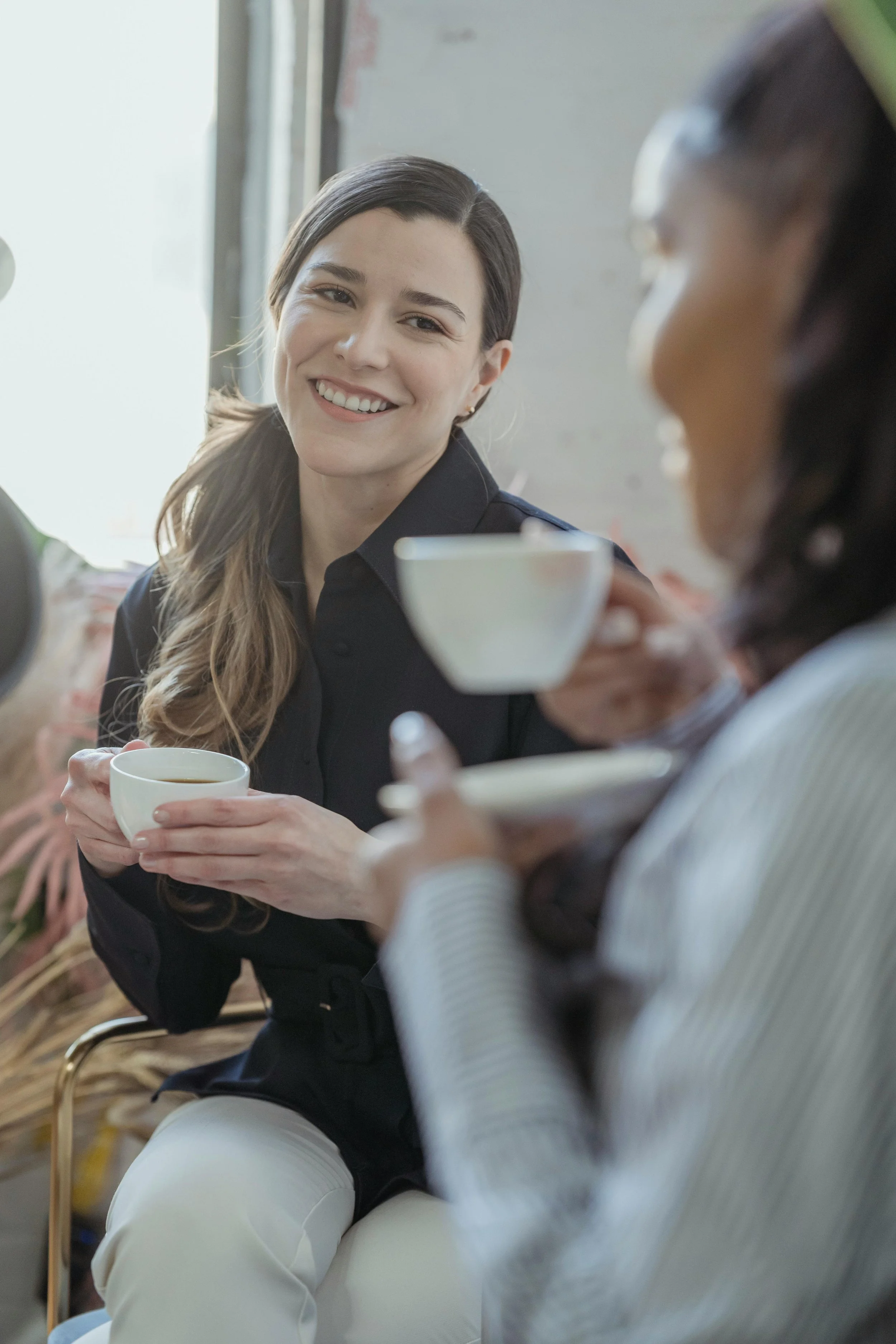 Two therapists consulting over coffee