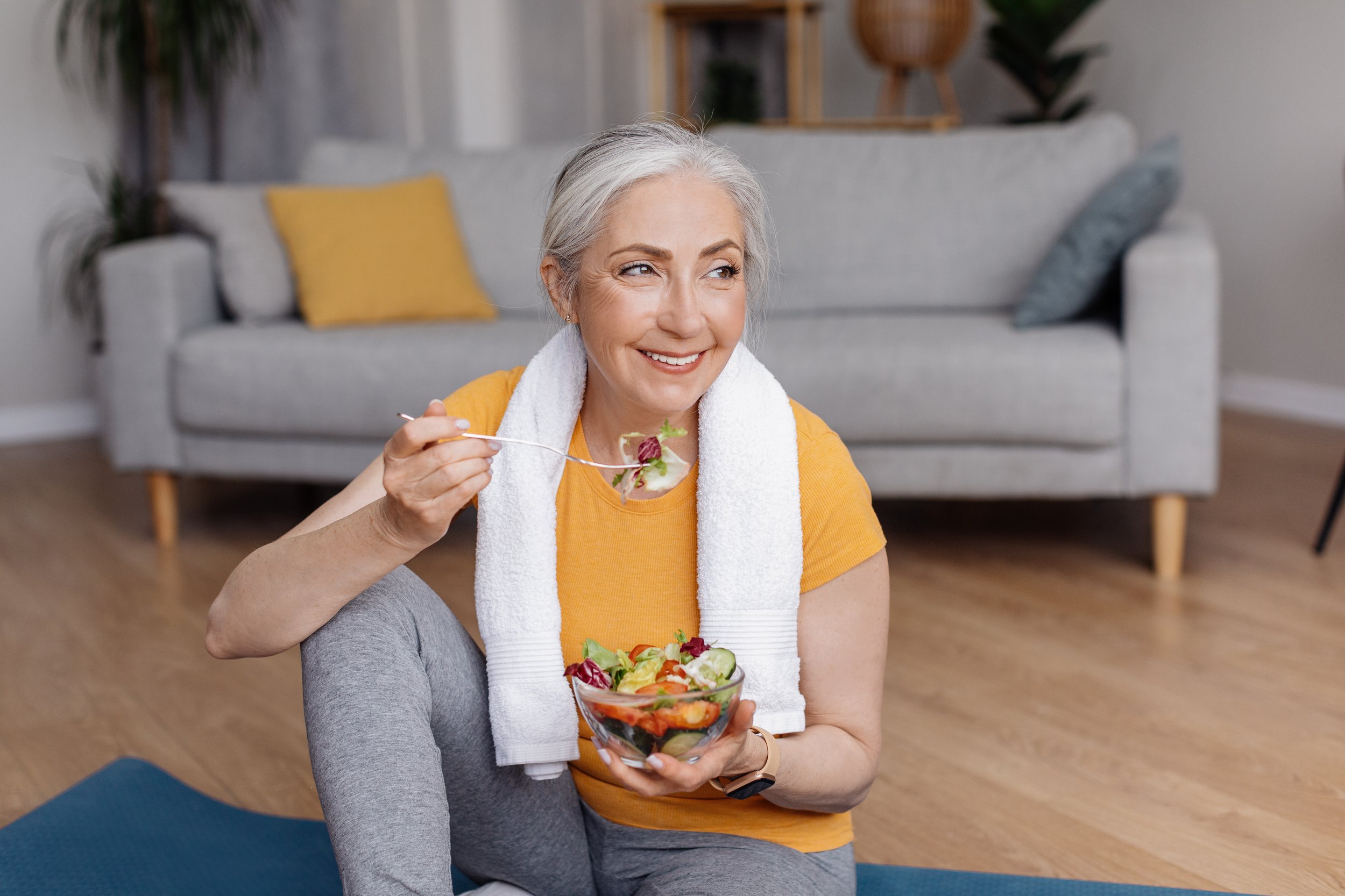 woman after working out eating healthy salad