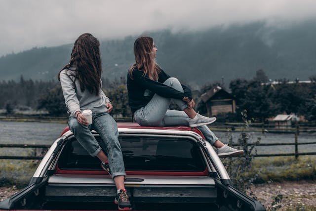 two women sitting atop truck Elijah Odonell