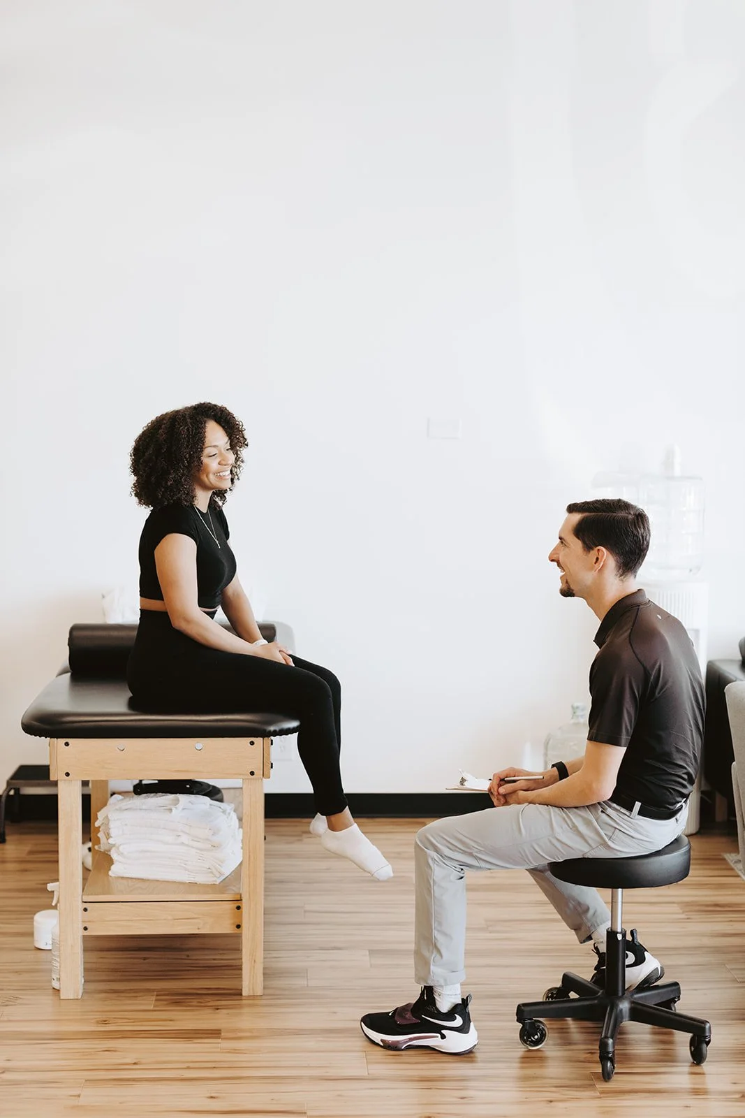 Physical therapist talking to a patient on their first visit.