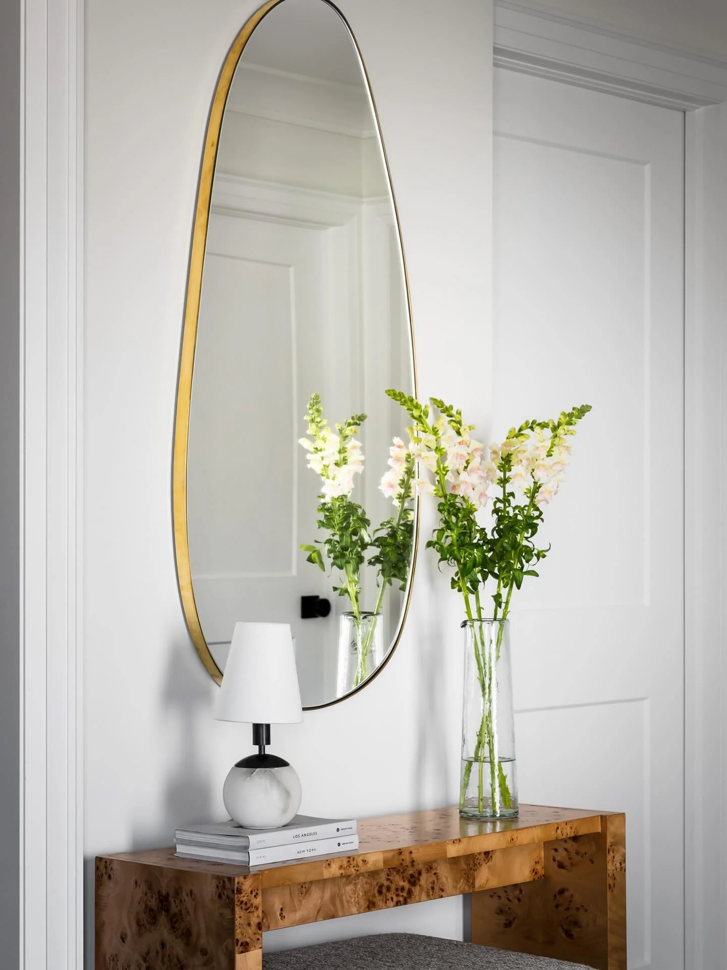 Clean lines, fresh florals, and a touch of texture make this entryway anything but ordinary