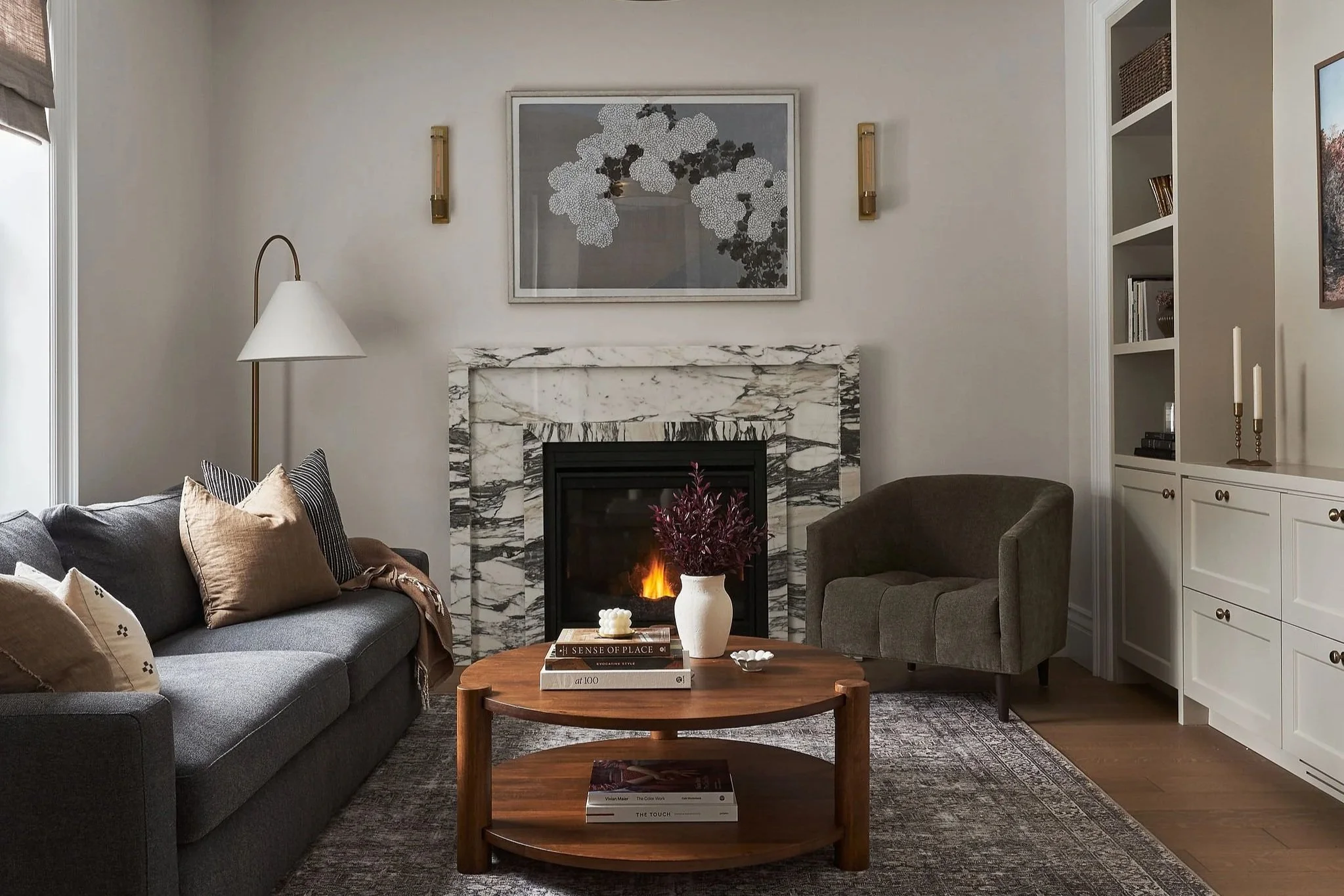 Century home living room with marble fireplace surround by Studio Moffatt in London, Ontario