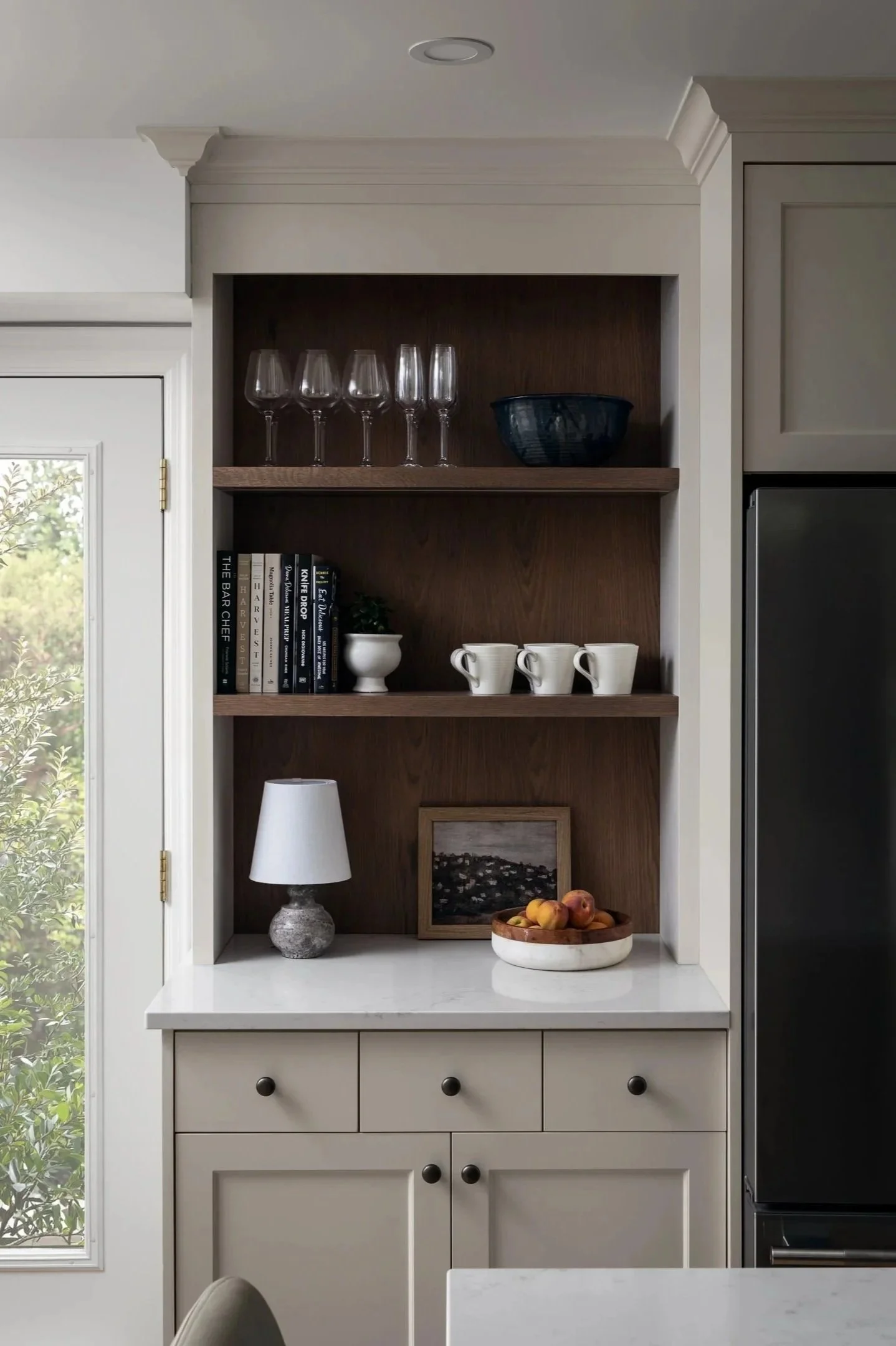 Coffee bar with custom off-white cabinets and stained red oak open shelves and back panel by Studio Moffatt in London, Ontario