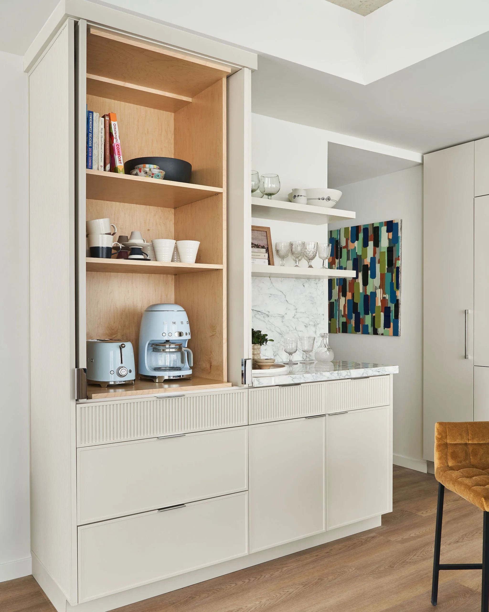 Hidden behind the cabinet doors is a functional appliance garage to store away small frequently used appliances.