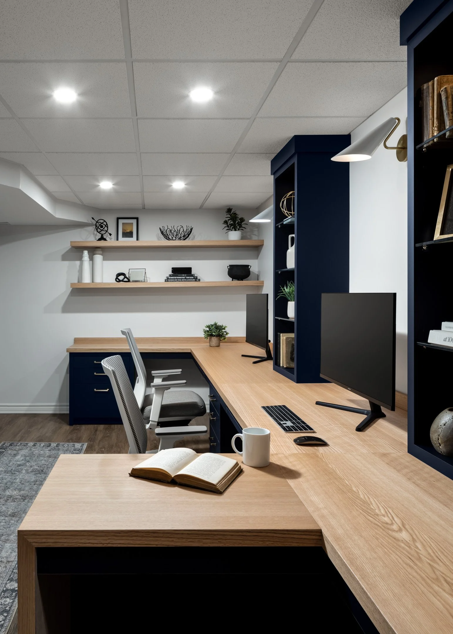 Home office with dark navy blue custom cabinetry, oak desktop and open shelves by Studio Moffatt in London, Ontario