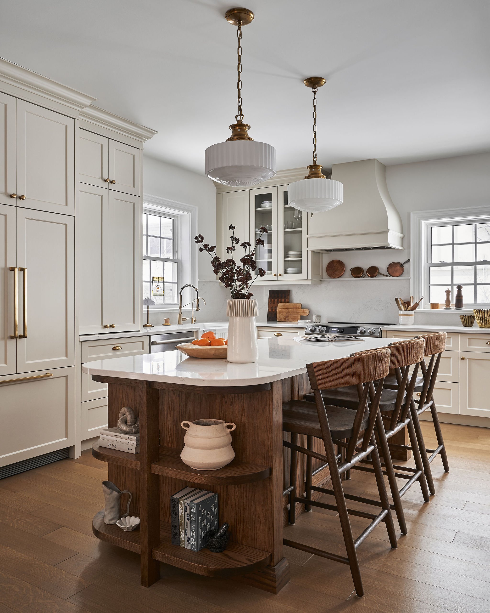 Timeless transitional kitchen in Century home with dark stained red oak island, off-white bespoke cabinetry and custom curved range hood with heirloom pendant lights by Studio Moffatt. London, Ontario