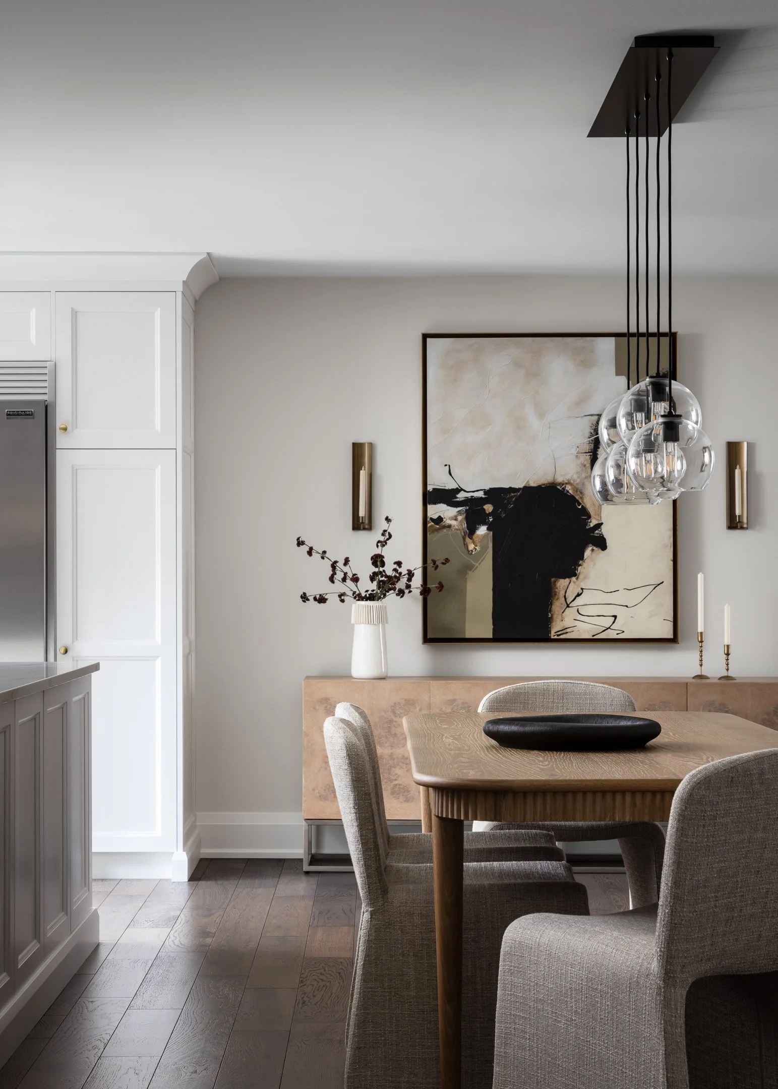 Dining Room with a rectangular oak dining table, upholstered modern chairs and abstract green and black artwork by Studio Moffatt, London, Ontario