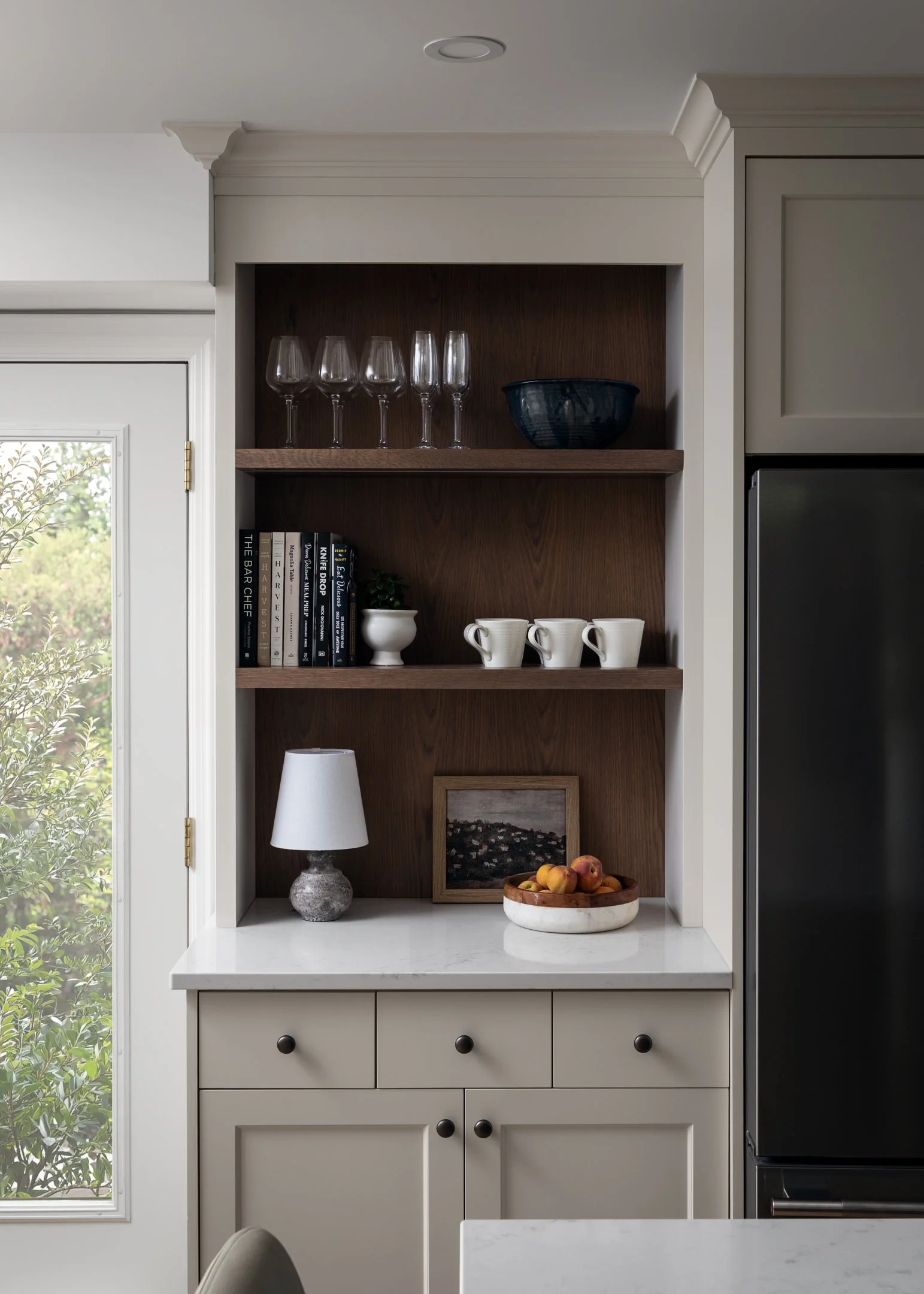 Coffee bar in custom kitchen with off-white bespoke cabinetry, red oak open shelving and back panel by Studio Moffatt in London, Ontario
