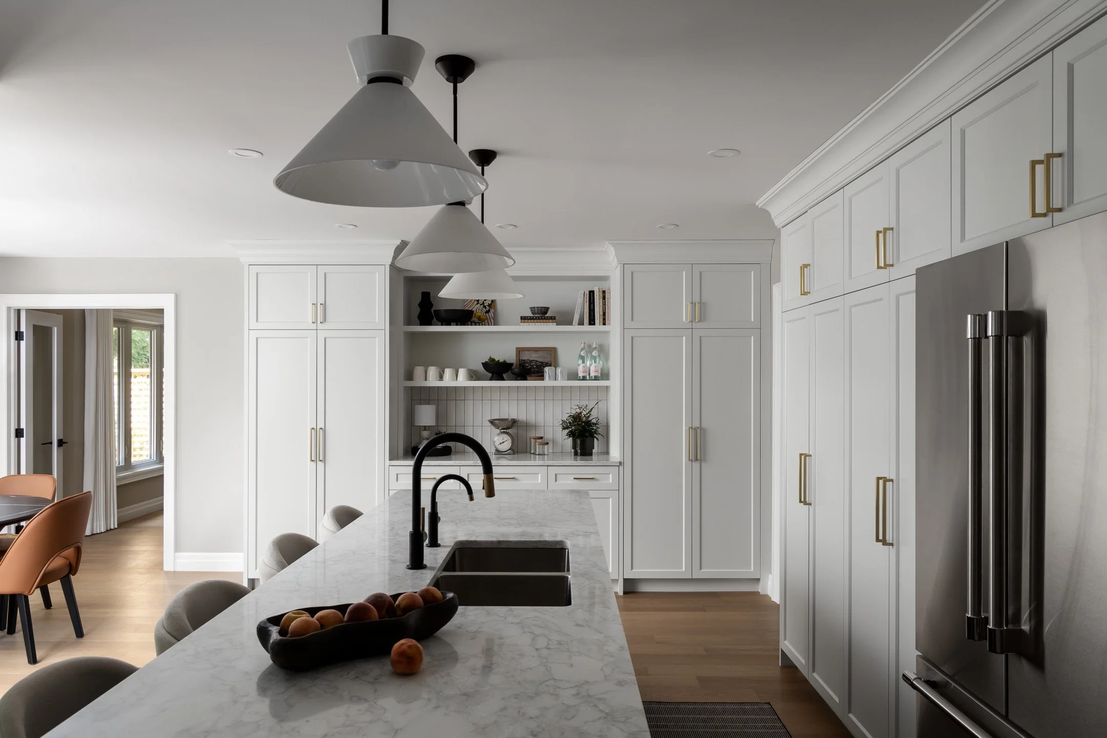 Residential renovation featuring a kitchen remodel with custom white cabinetry and quartz countertops.  Interior Design project by Studio Moffatt in London, Ontario
