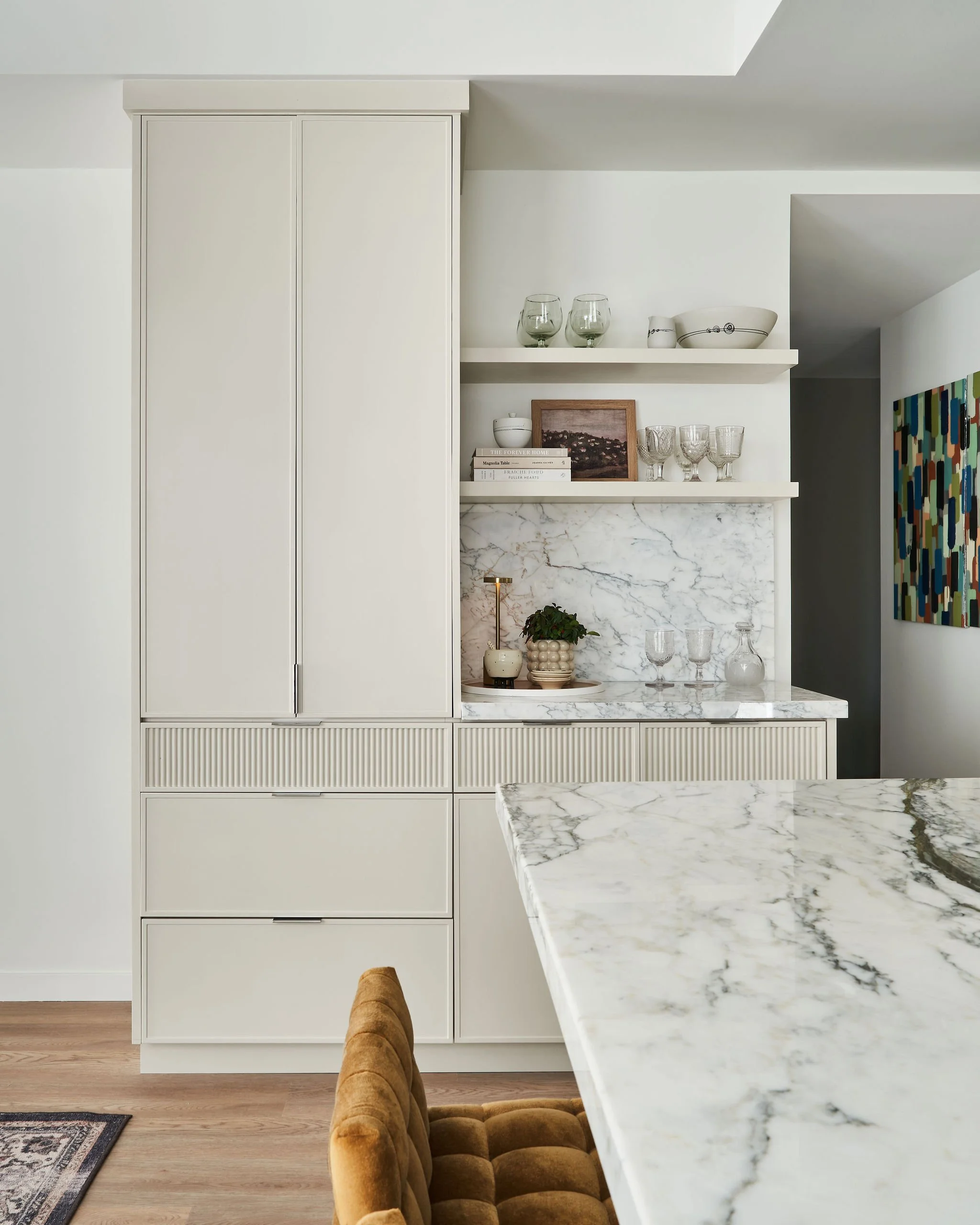 Custom cabinetry with reeded top drawers