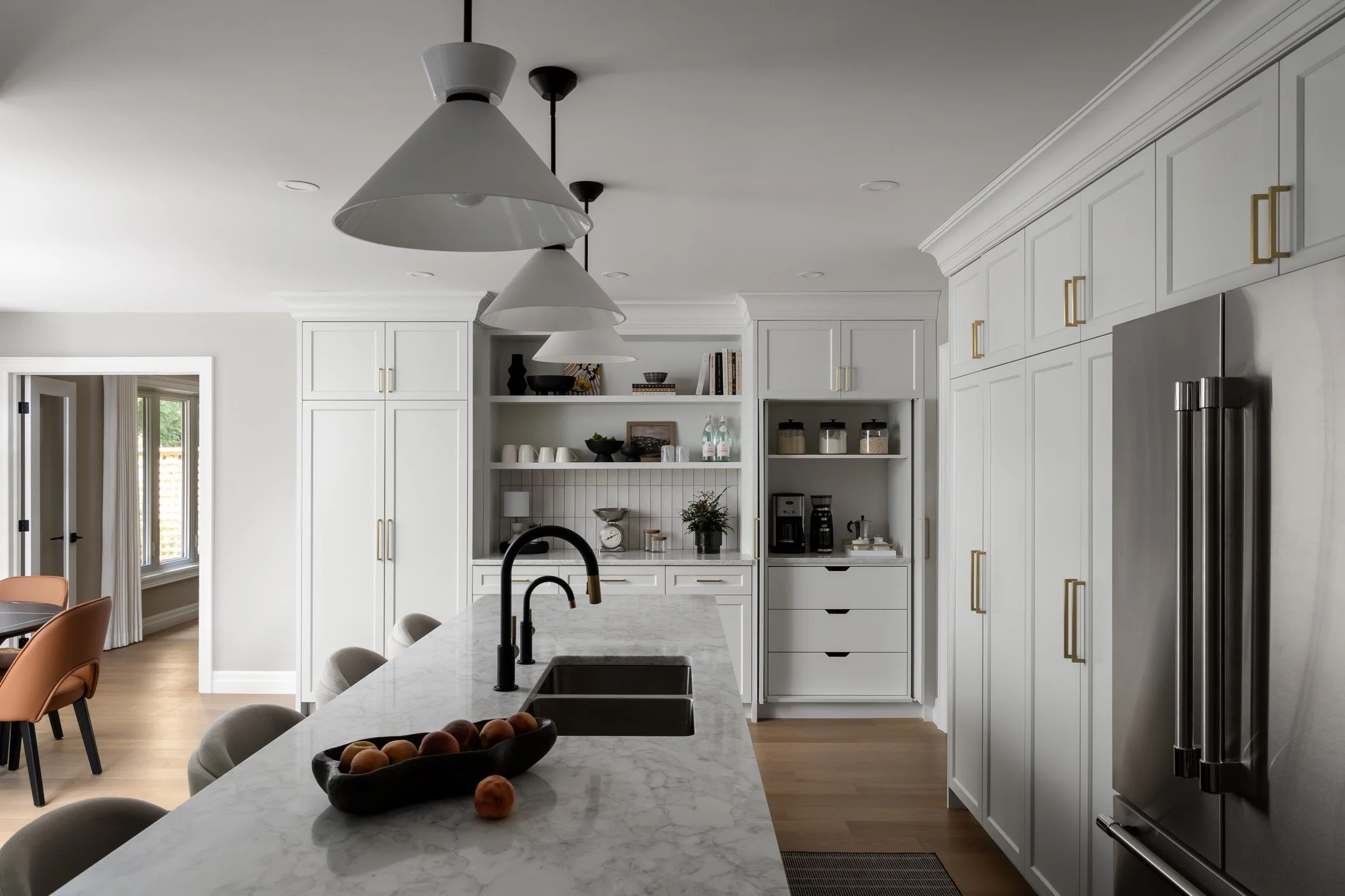 Residential renovation featuring a kitchen remodel with custom white cabinetry and quartz countertops.  Interior Design project by Studio Moffatt in London, Ontario