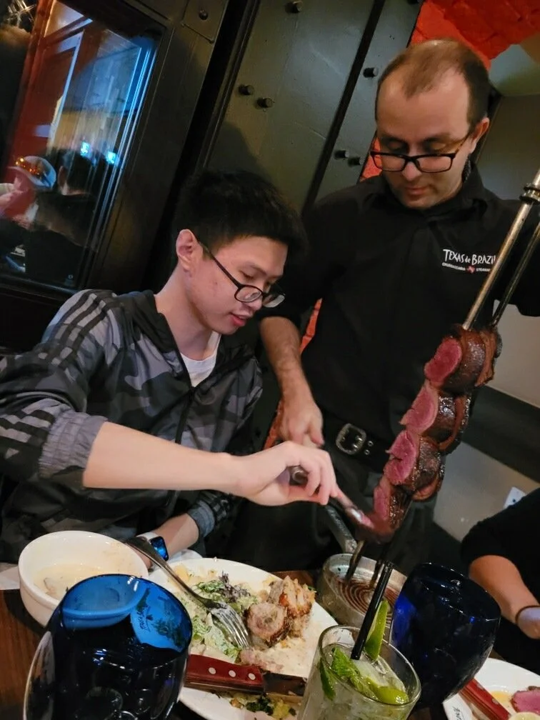 Yefan enjoying his first meal at a Brazilian steakhouse