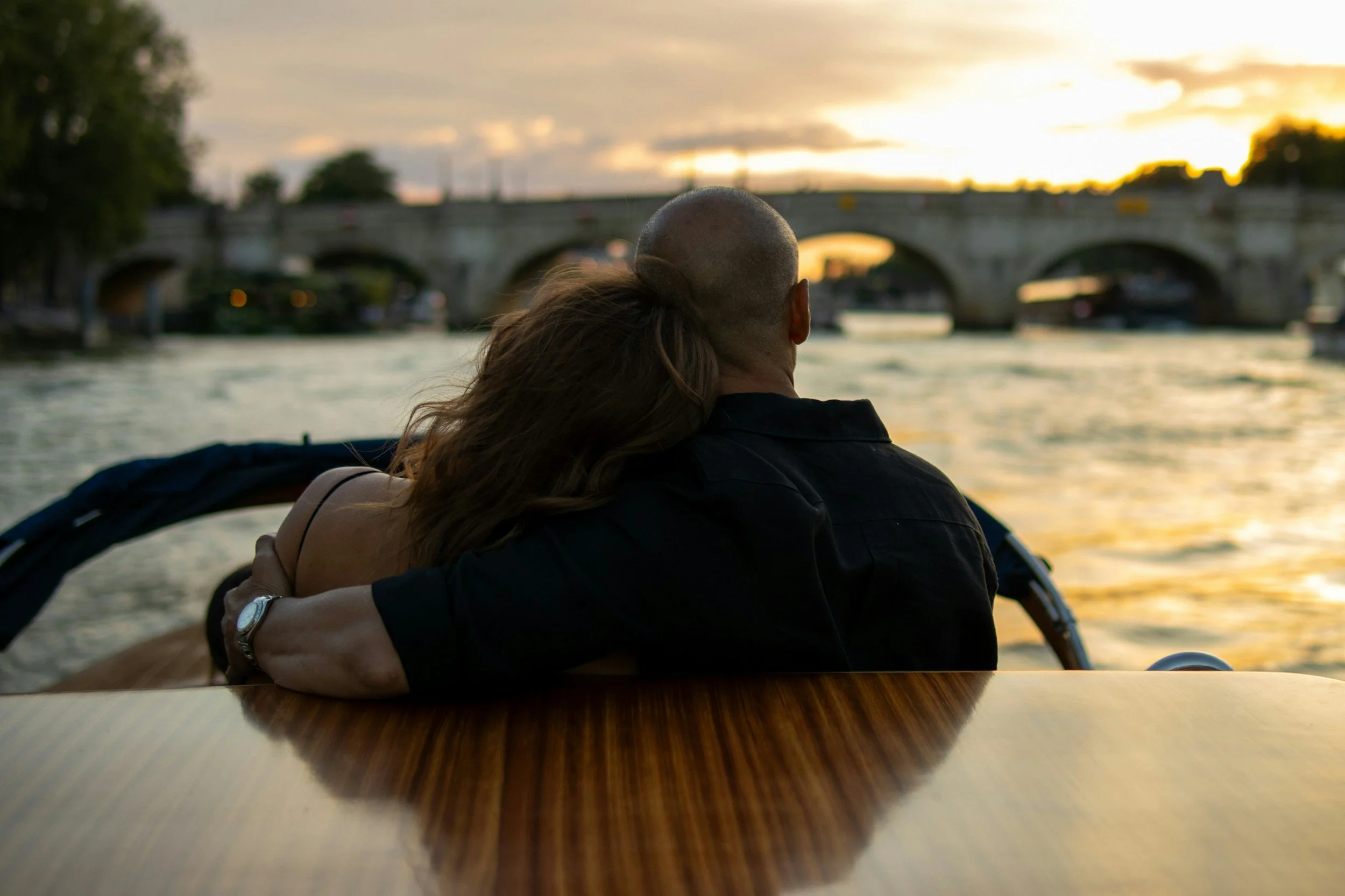 Couple holding each other while boating down the river.