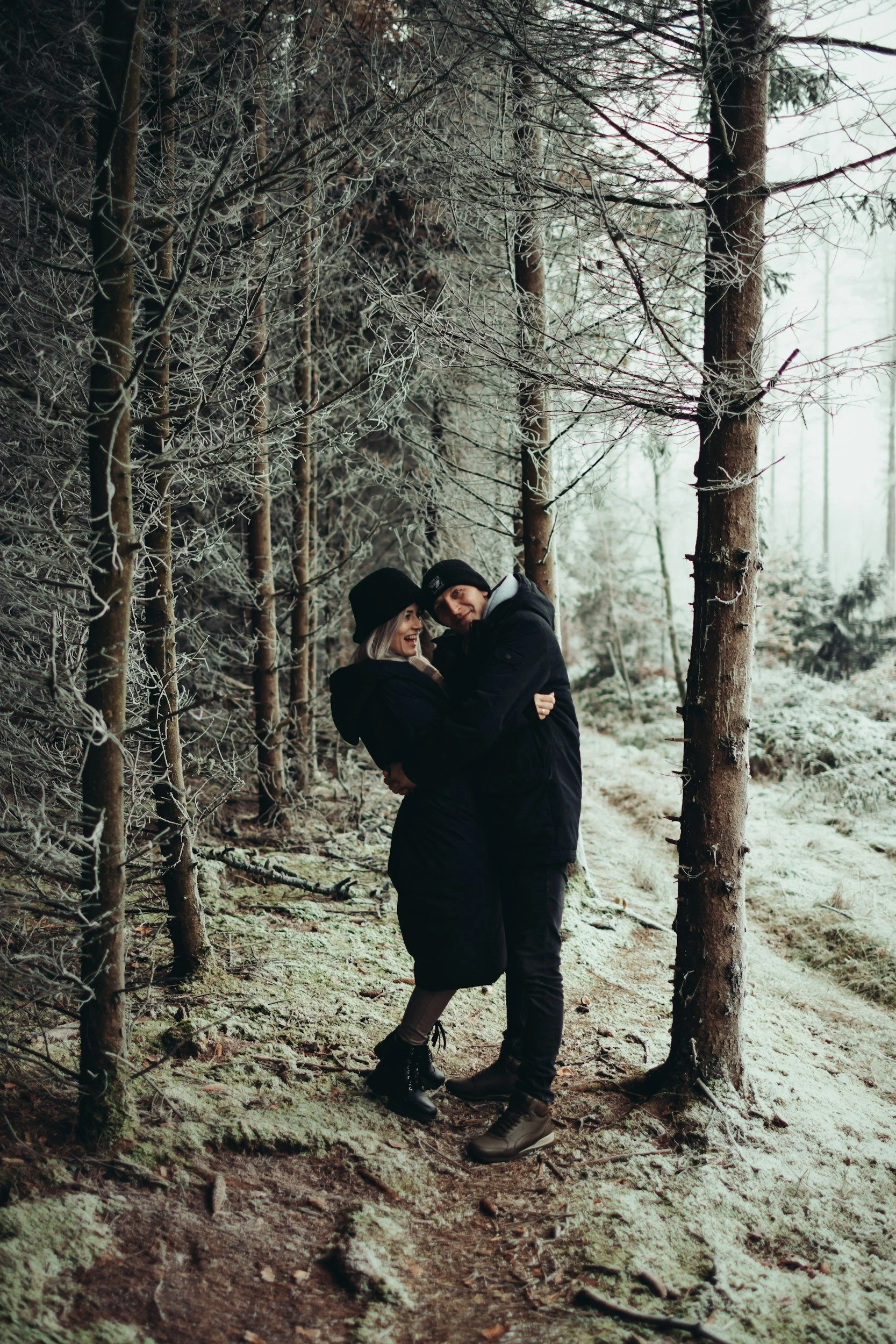 couple in forest and hugging and smiling