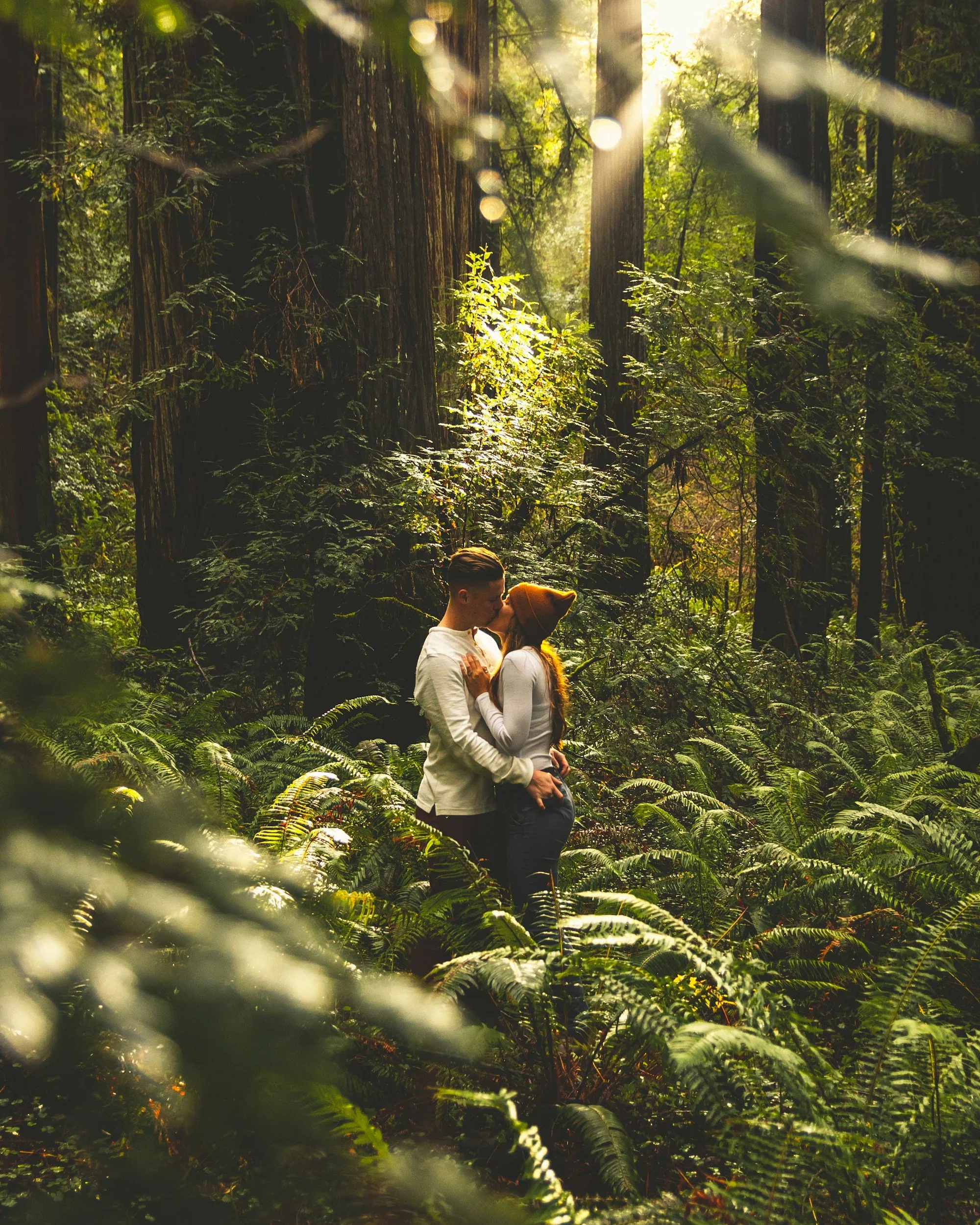 couple kissing in forest