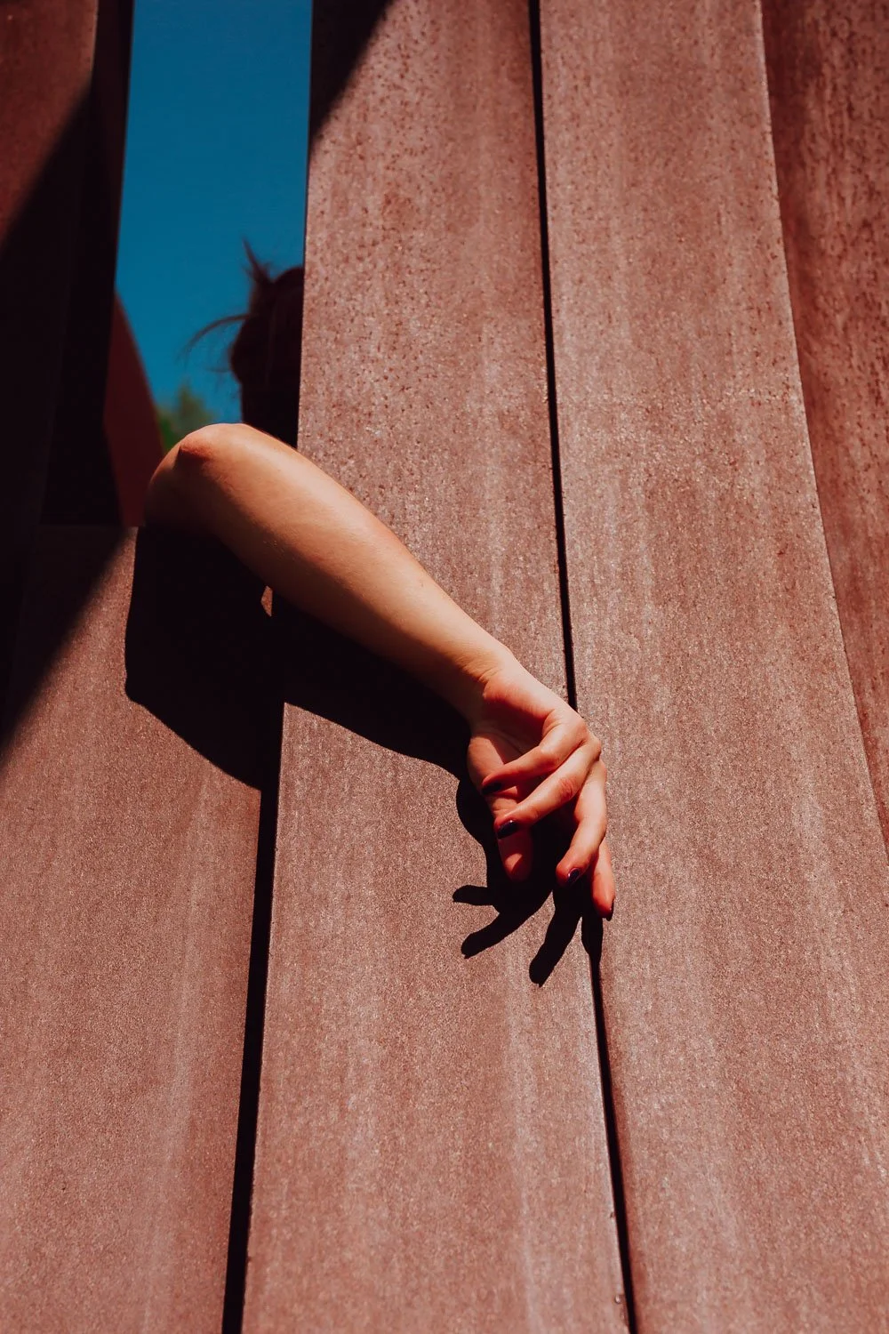 A photo of NYC Kinky Redhead Escort Julia Flowerbomb posing with her arm out.