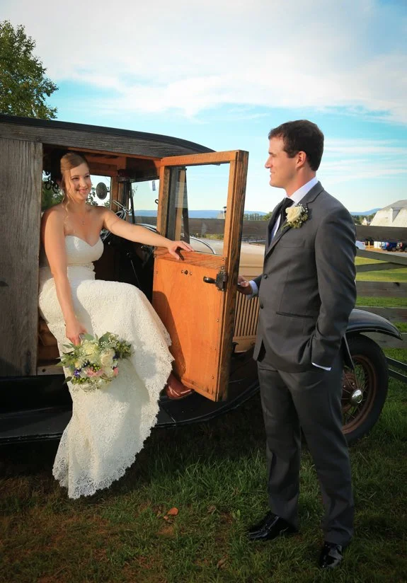 Bride and groom talking with classic car at Walker's Overlook
