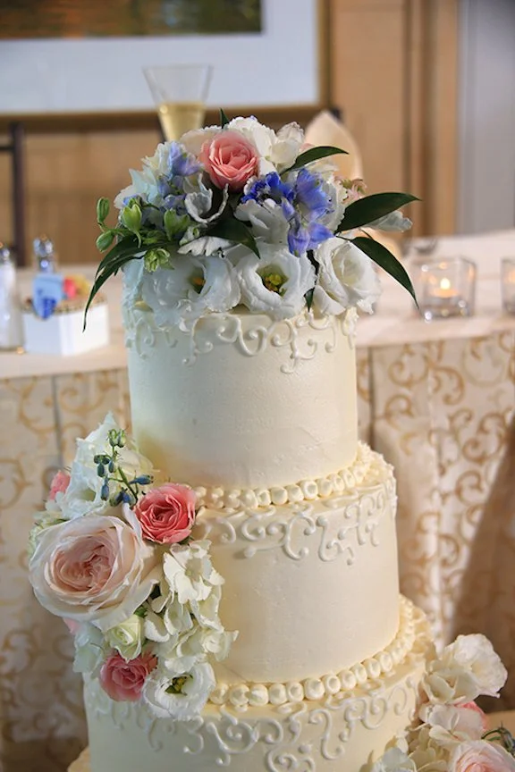 wedding cake white with blue and pink flowers