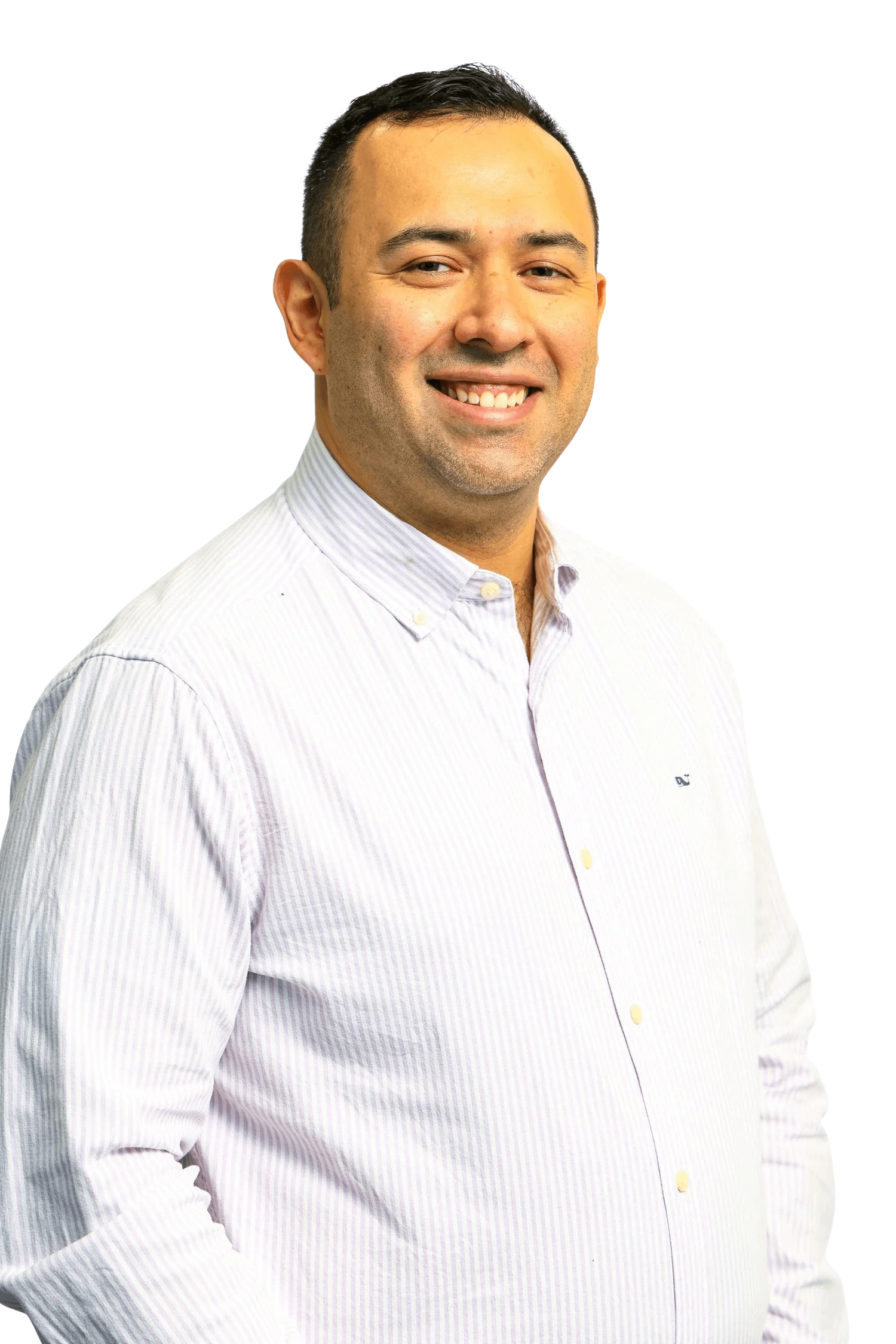 A man with dark hair and a light complexion, wearing a white striped button-up shirt, smiling at the camera against a white background.