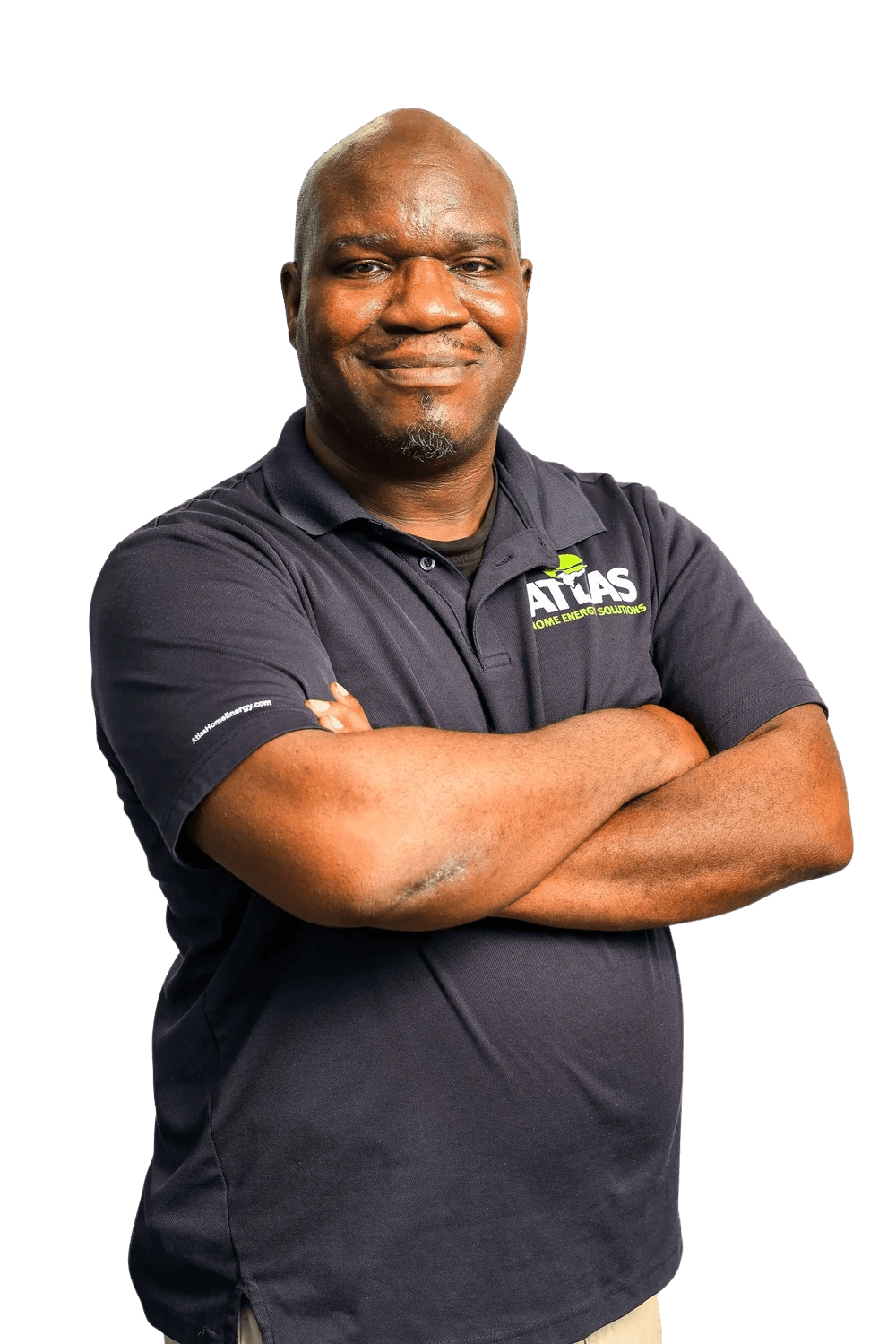 Portrait of a smiling African American man with a shaved head, wearing a dark polo shirt with the logo 'ATLAS Home Energy Solutions,' standing with crossed arms against a black background.