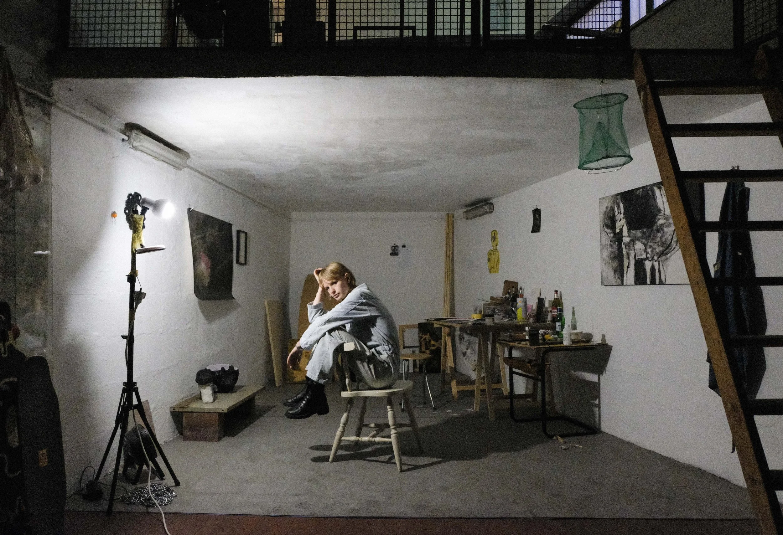 Janneke Leenders sitting on a chair in her art studio.