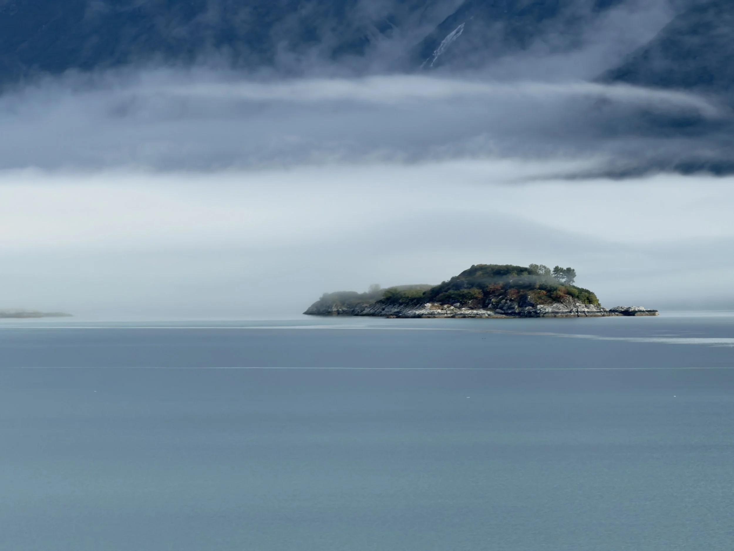  A pretty little island shrouded in a foggy mist in Glacier Bay National Park 