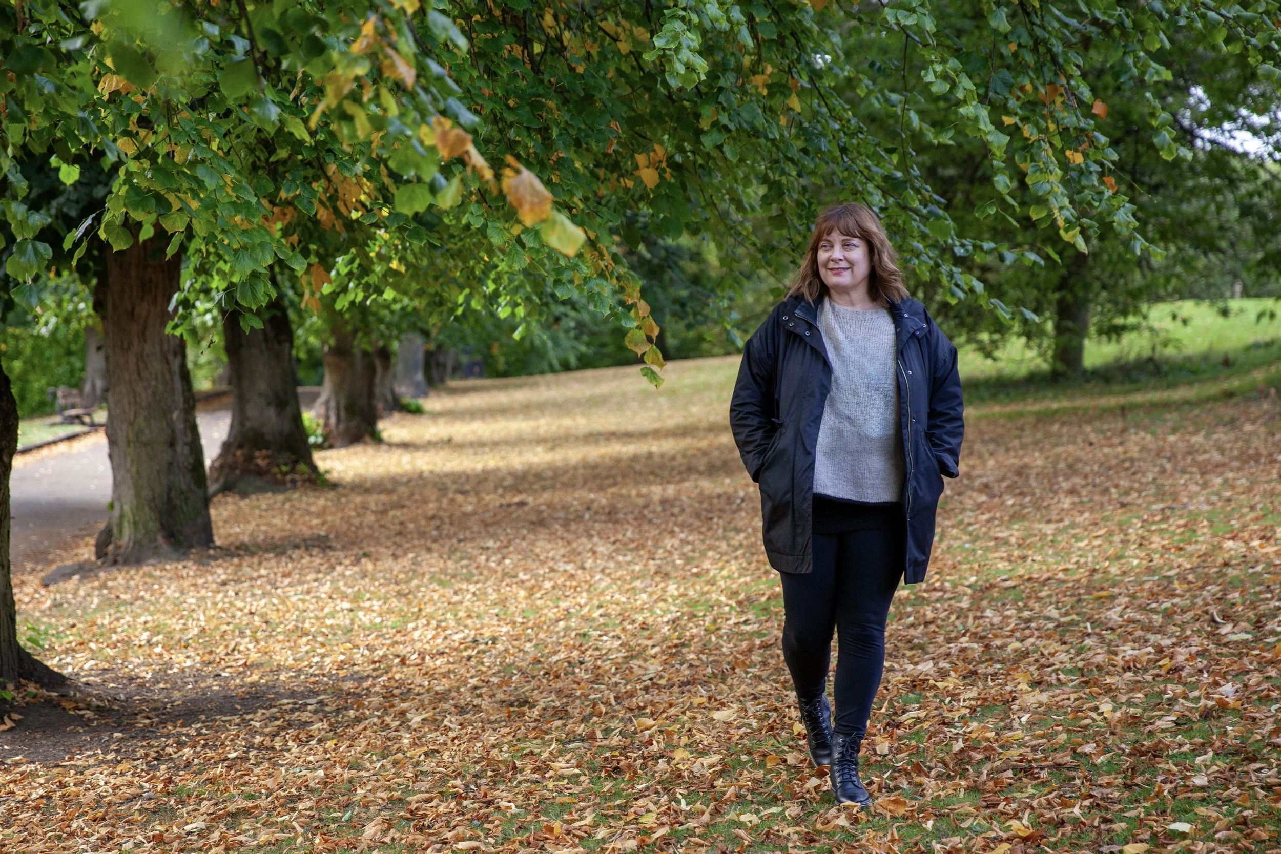 Sam Richardson on an autumn walk, reflecting on her journey and the experiences that led to creating Back to You™.
