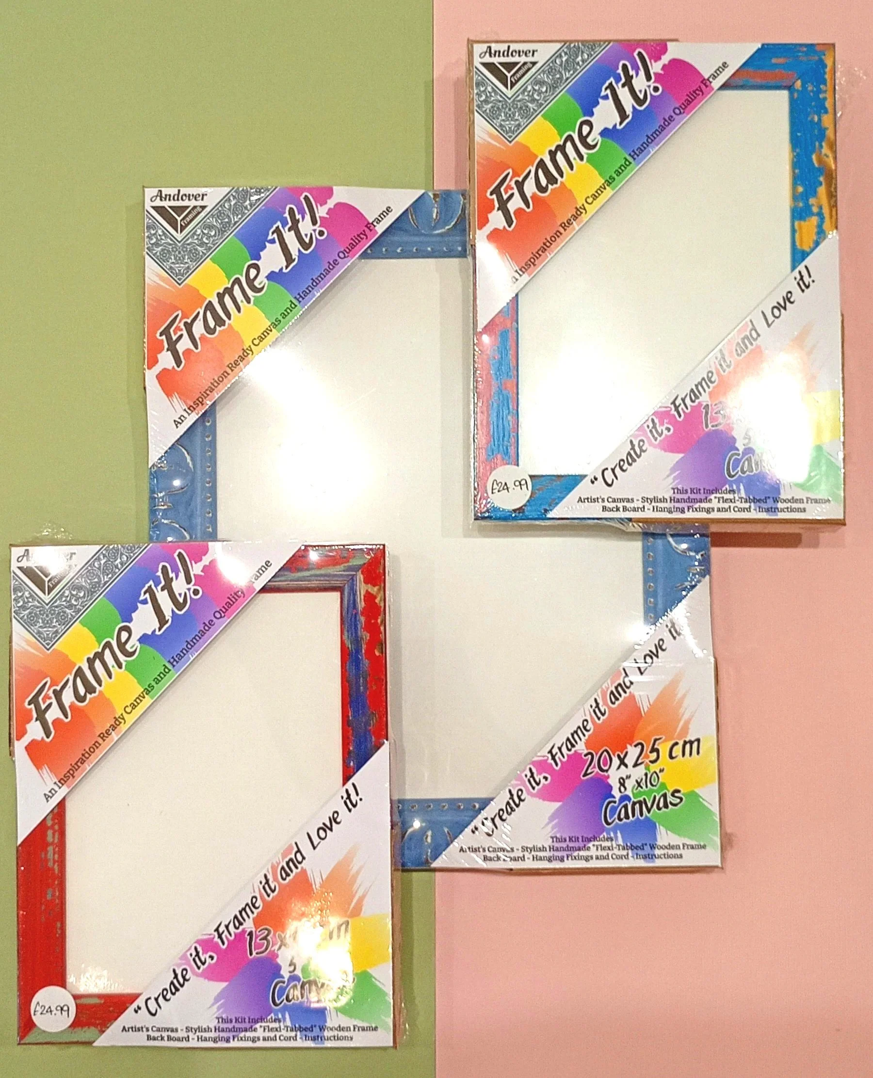 Two colorful decorative picture frames in packaging, one with a red border and one with a blue border, displayed on a wall with green and pink paint.