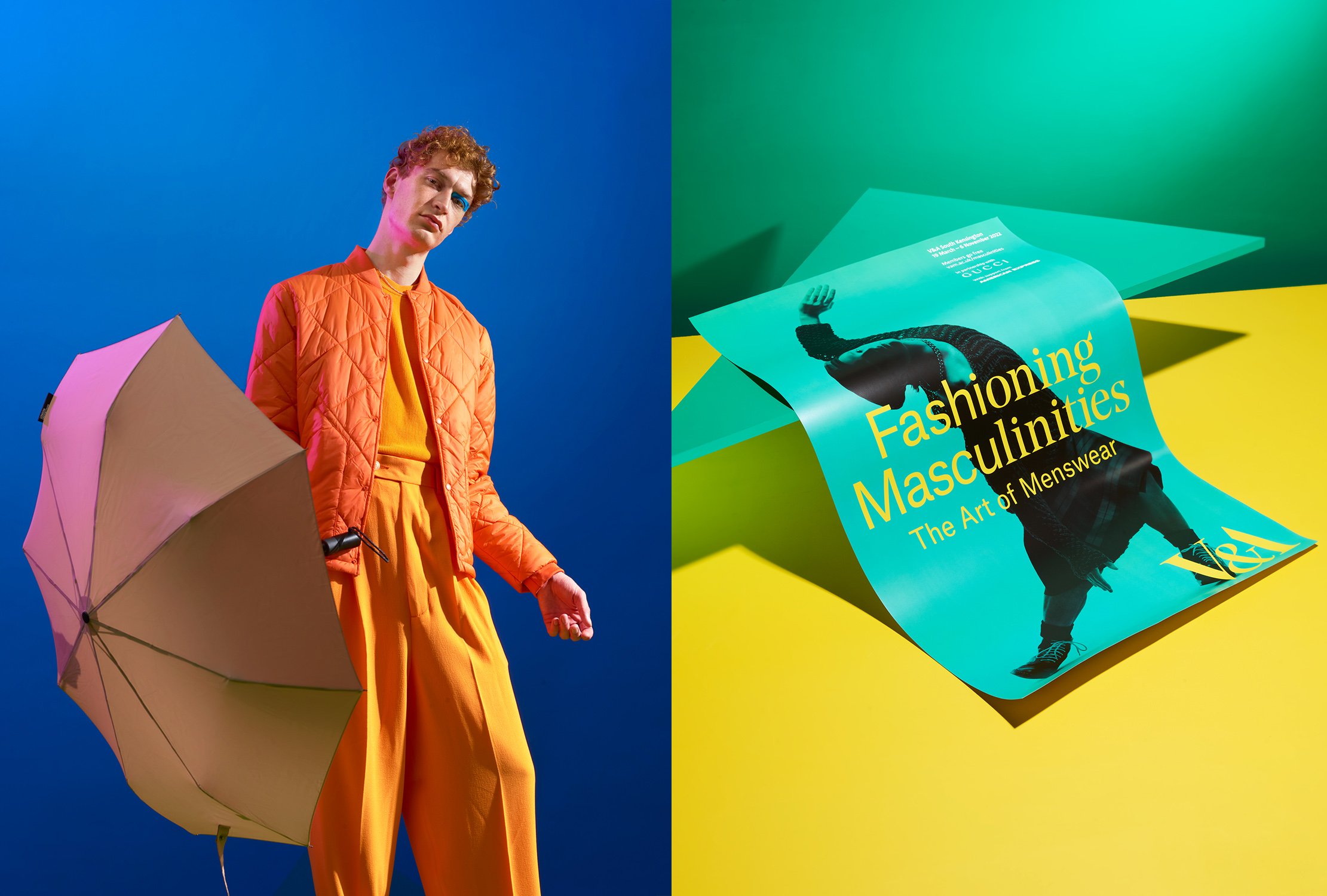 Photo of a person with curly hair wearing an orange quilted jacket and yellow pants, holding a pink and beige umbrella against a blue background. Next to them is a colorful poster titled 'Fashioning Masculinities: The Art of Menswear', featuring an i