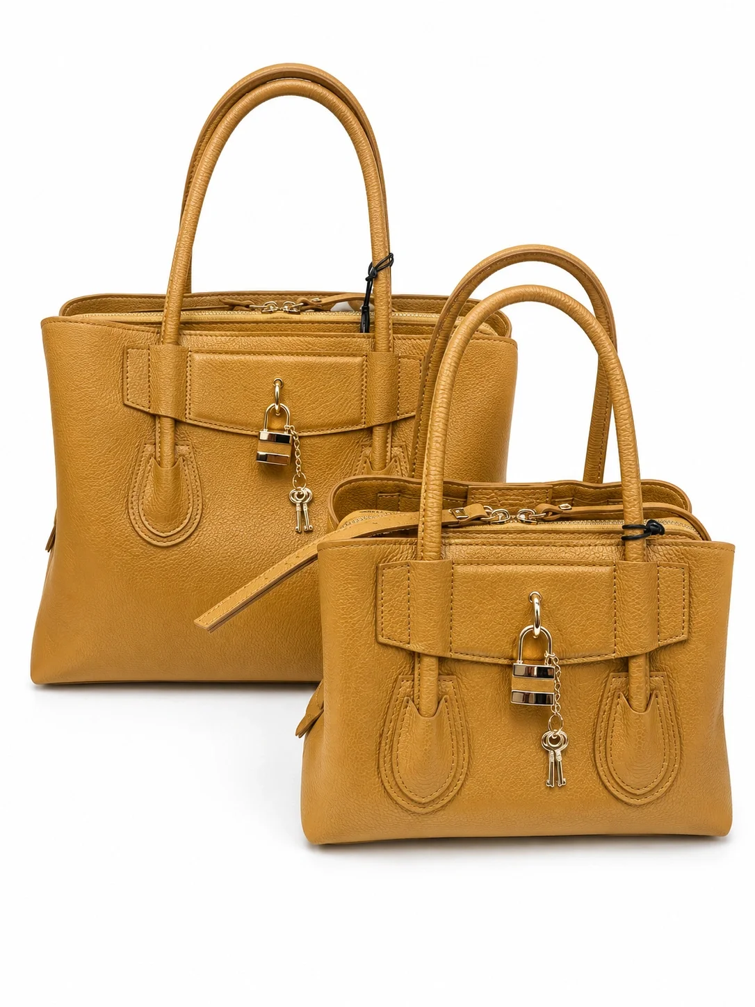 Two yellow leather handbags with gold and silver charms hanging from the front, placed against a white background.
