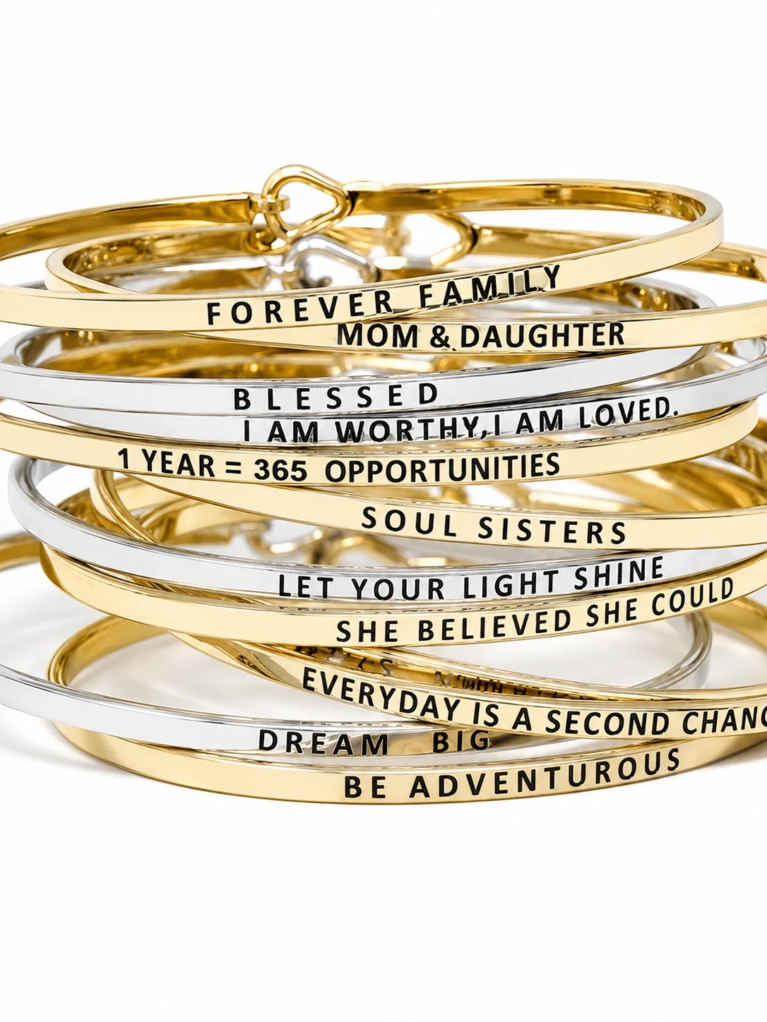 Stacked gold and silver bracelets with engraved motivational and family messages such as 'FOREVER FAMILY,' 'MOM & DAUGHTER,' 'BLESSED,' and 'LET YOUR LIGHT SHINE'