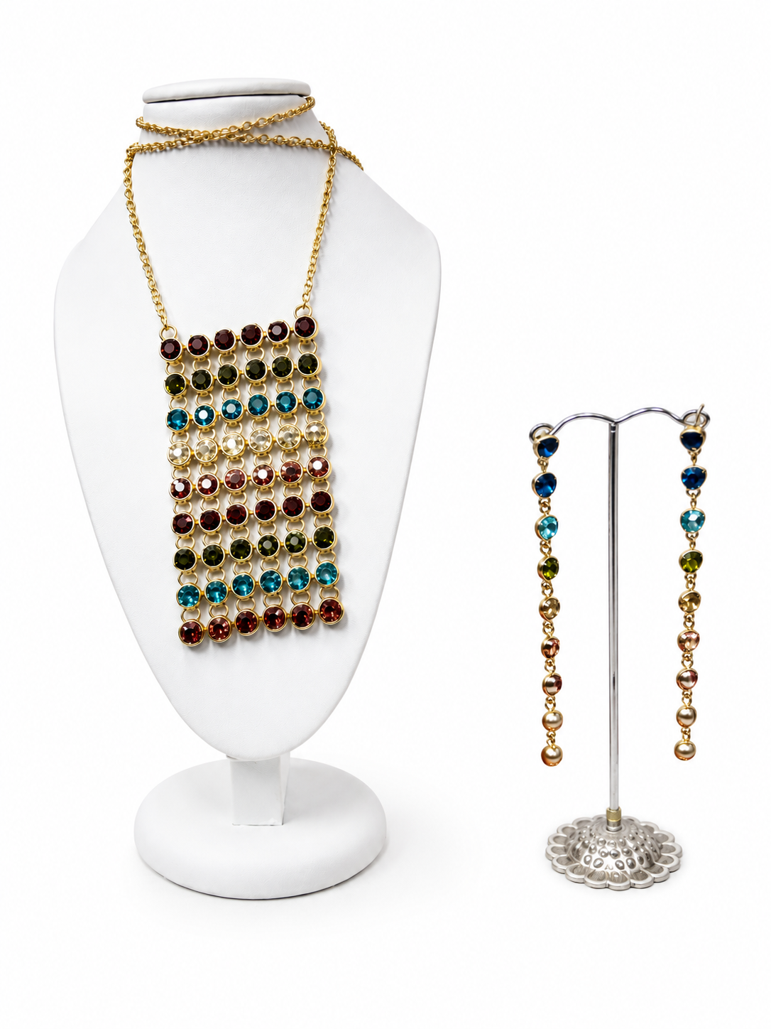 Colorful jewelry set with gold chains and multicolored beads displayed on a white jewelry bust and a bracelet stand.