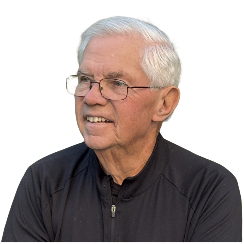 Senior man with white hair and glasses wearing a black zip-up jacket, looking to the side with a slight smile.