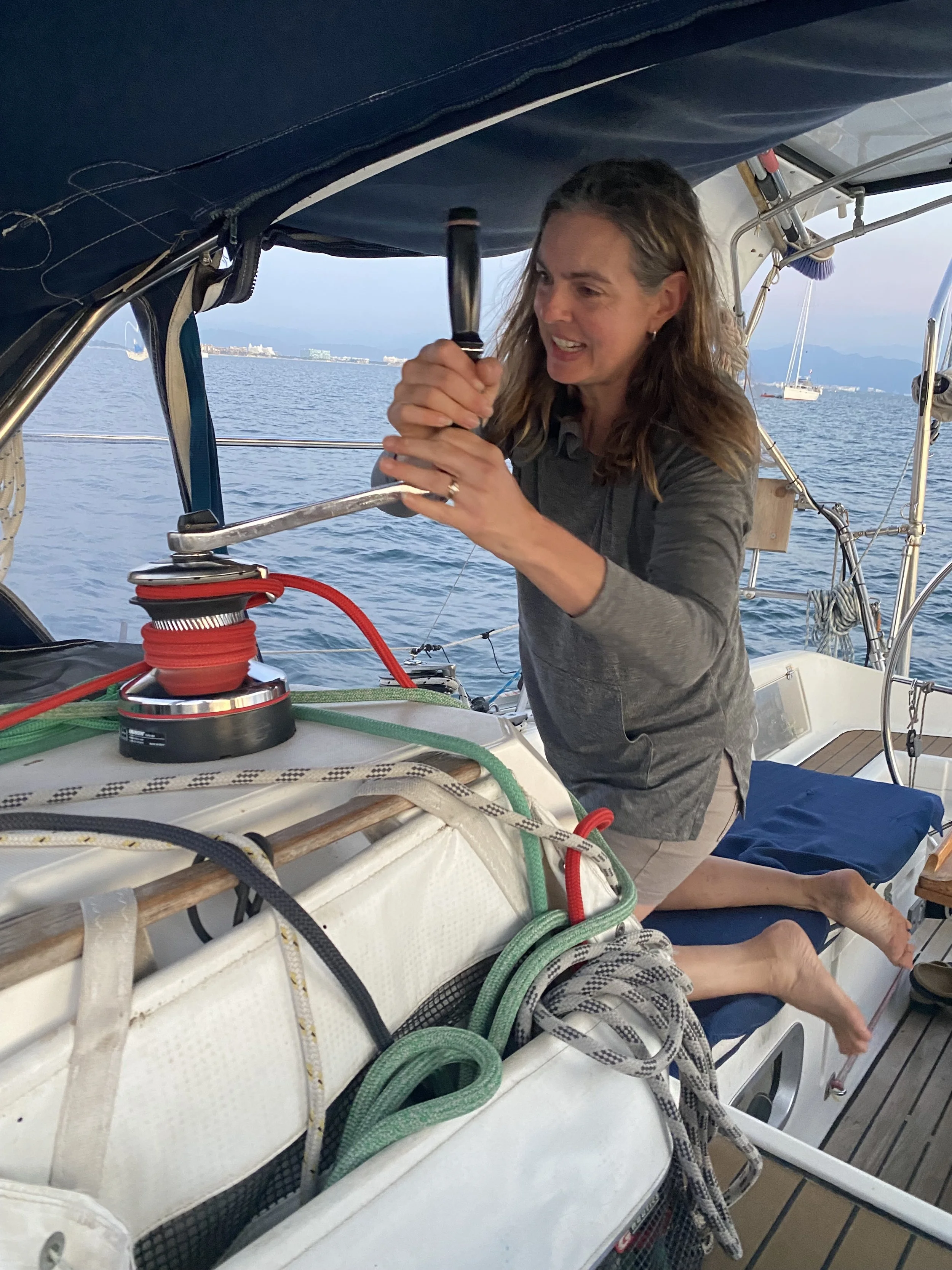 Student learning how to hoist a sail
