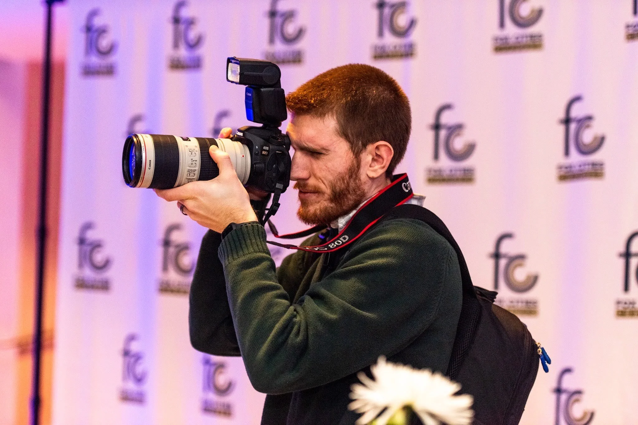 Alex Vassios shooting pictures at an event