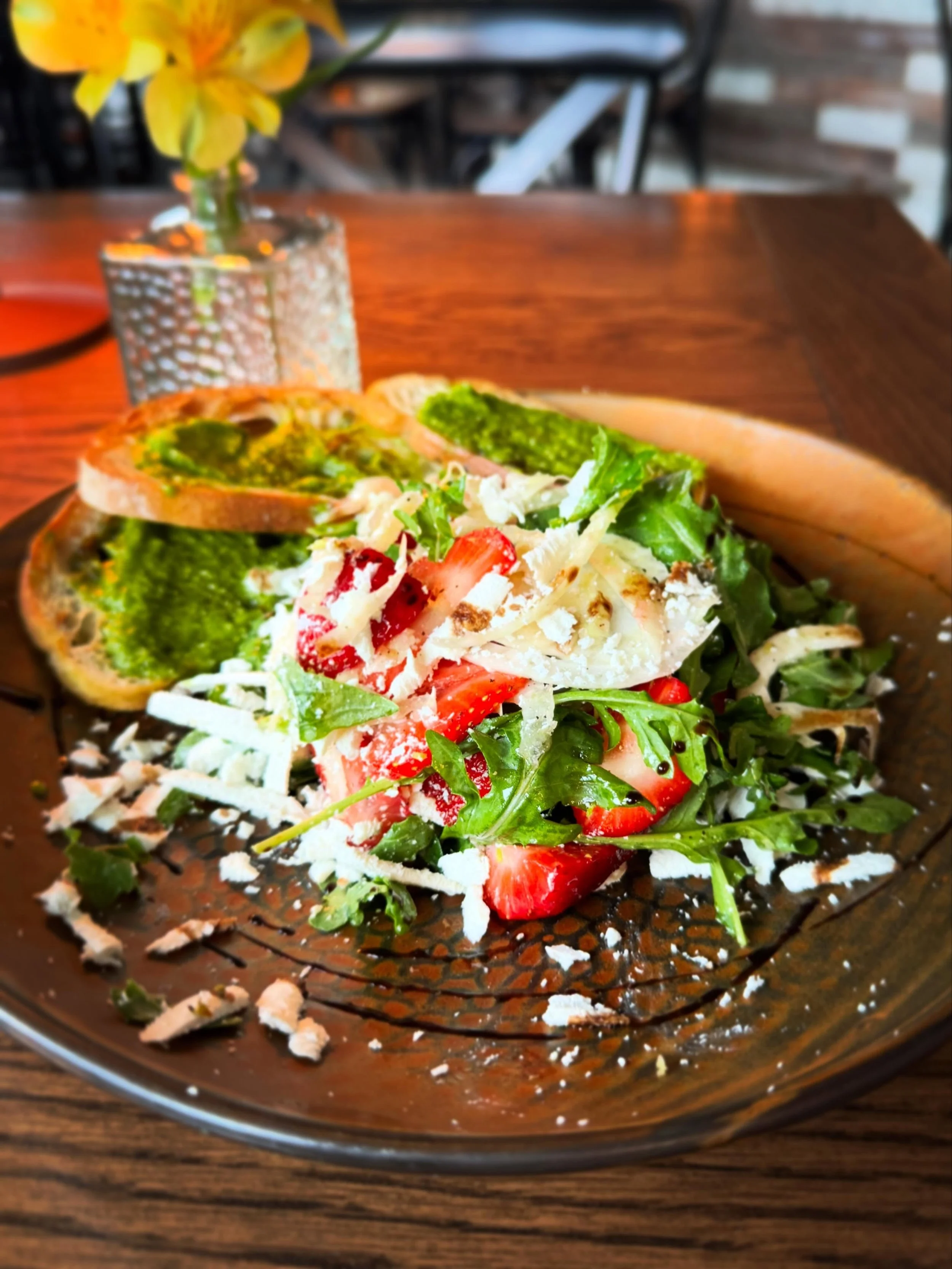 Though it may not feel like spring outside, the plate tells a different story. Tonight&rsquo;s salad celebrates the season with local strawberries, fresh herbs, ricotta salata, and a bright ramp pesto crostini. Ramps&mdash;wild leeks with a pungent g