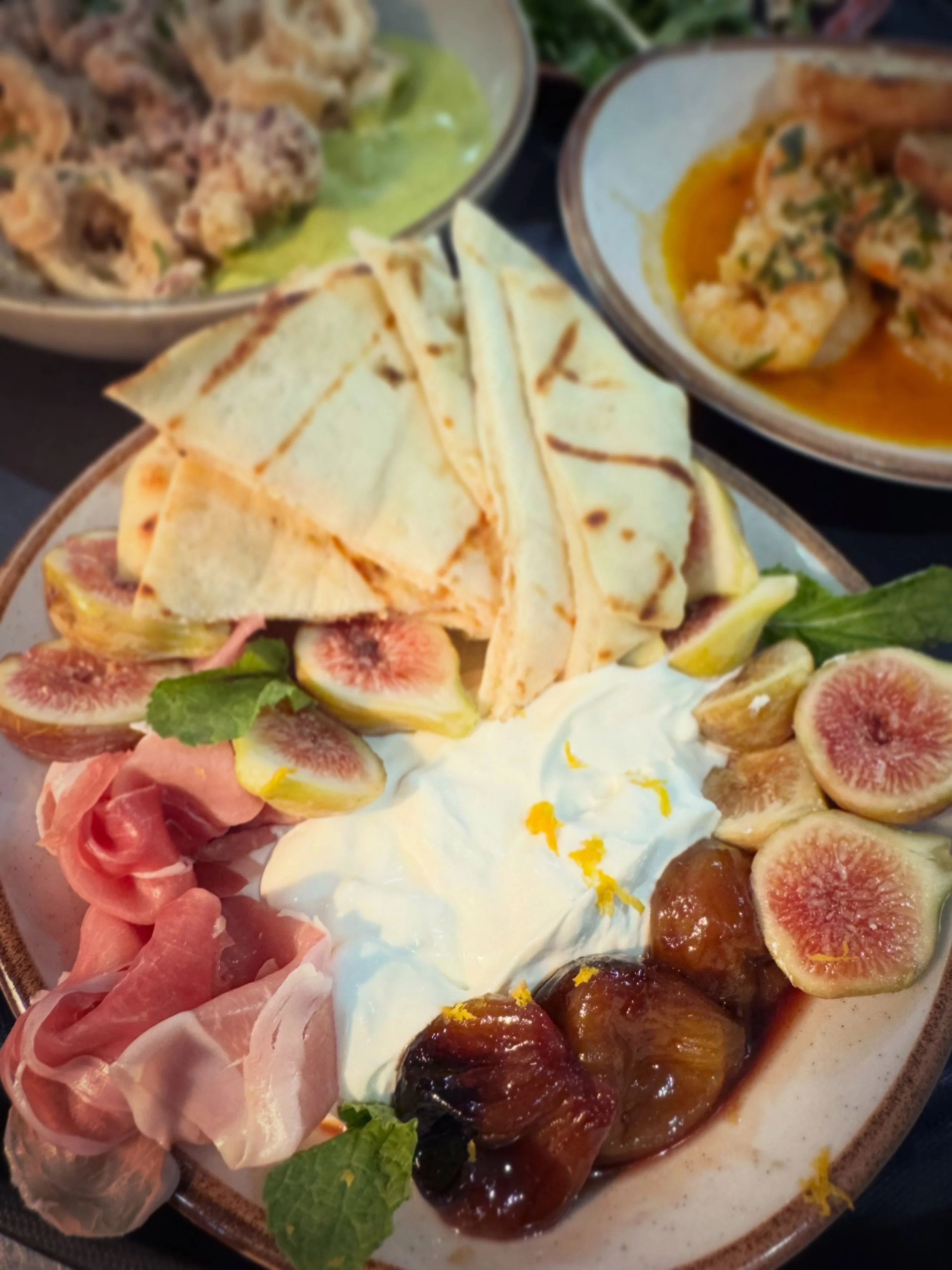 Today Chef Mike is doubling down on figs! This appetizer special features our local summertime favorite two ways &mdash; fresh and caramelized &mdash; perfectly complemented by tangy honey-whipped goat cheese and salty prosciutto. Join us for dinner 