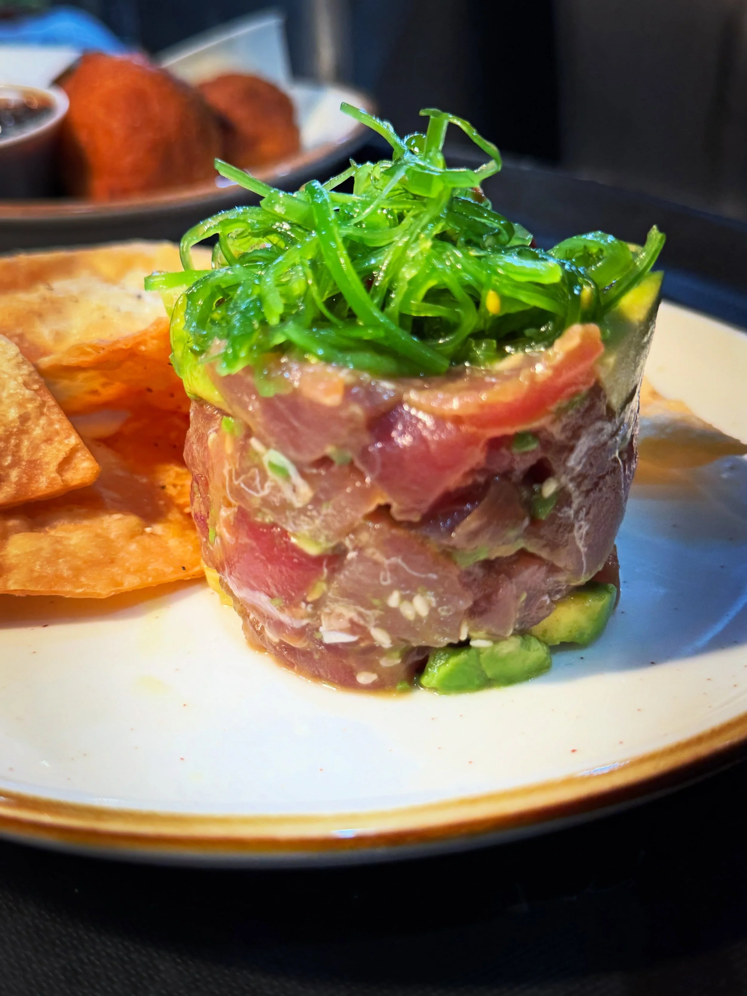 Fresh tuna, soy, lime, avocado, and toasted sesame seeds finished with and a little nest of seaweed salad &mdash; fresh and ready to enjoy with house fried tortillas. One of this summer&rsquo;s favorite starters at The Village!
&bull;
#appetizer #sum