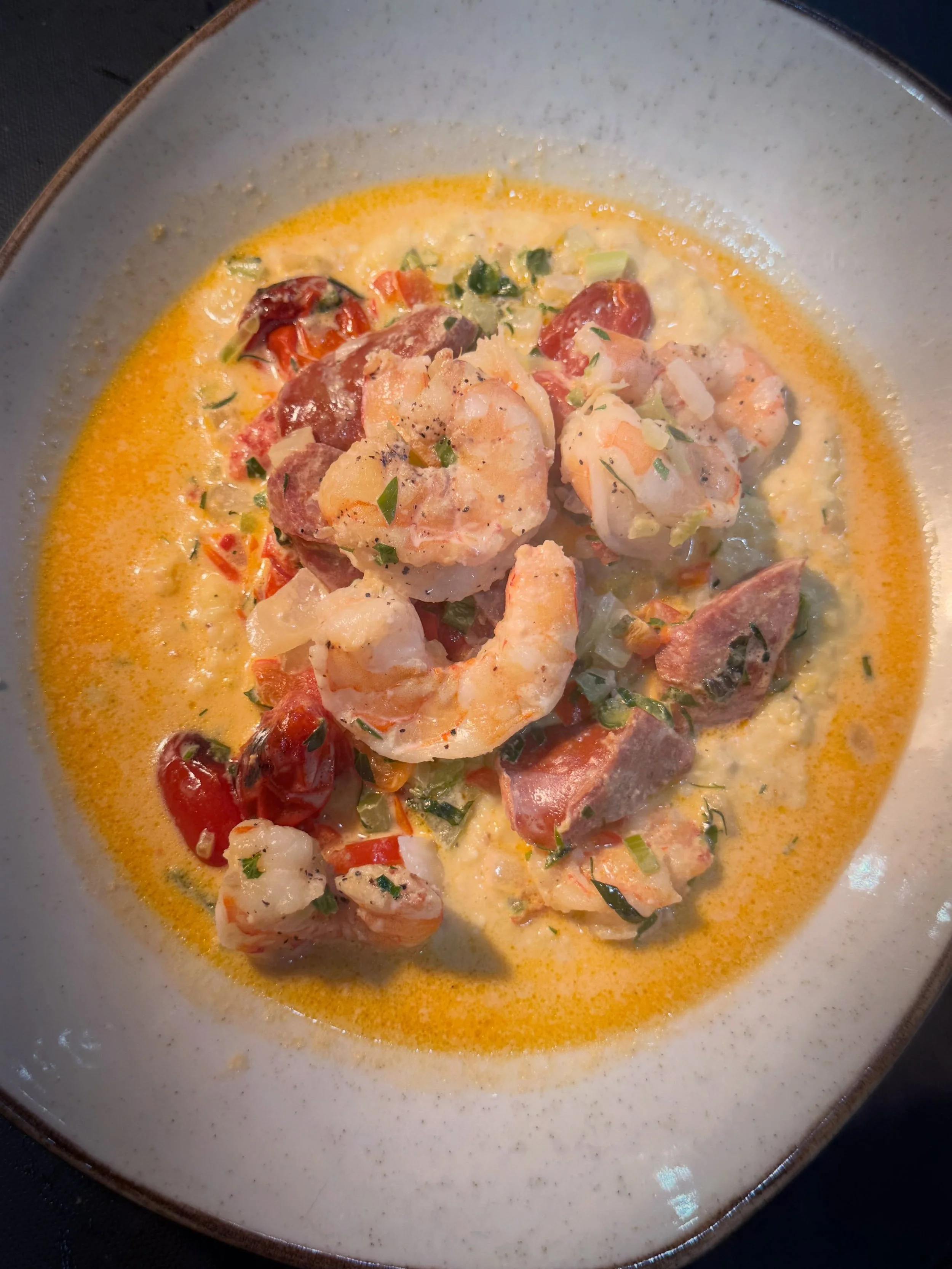 Shrimp &amp; Grits: a southern staple done right with local greentail shrimp, andouille sausage, charred baby tomatoes, and fresh tarragon. Just one of the Tavern Classics you&rsquo;ll find on our menu. See our full menu and reserve your table throug