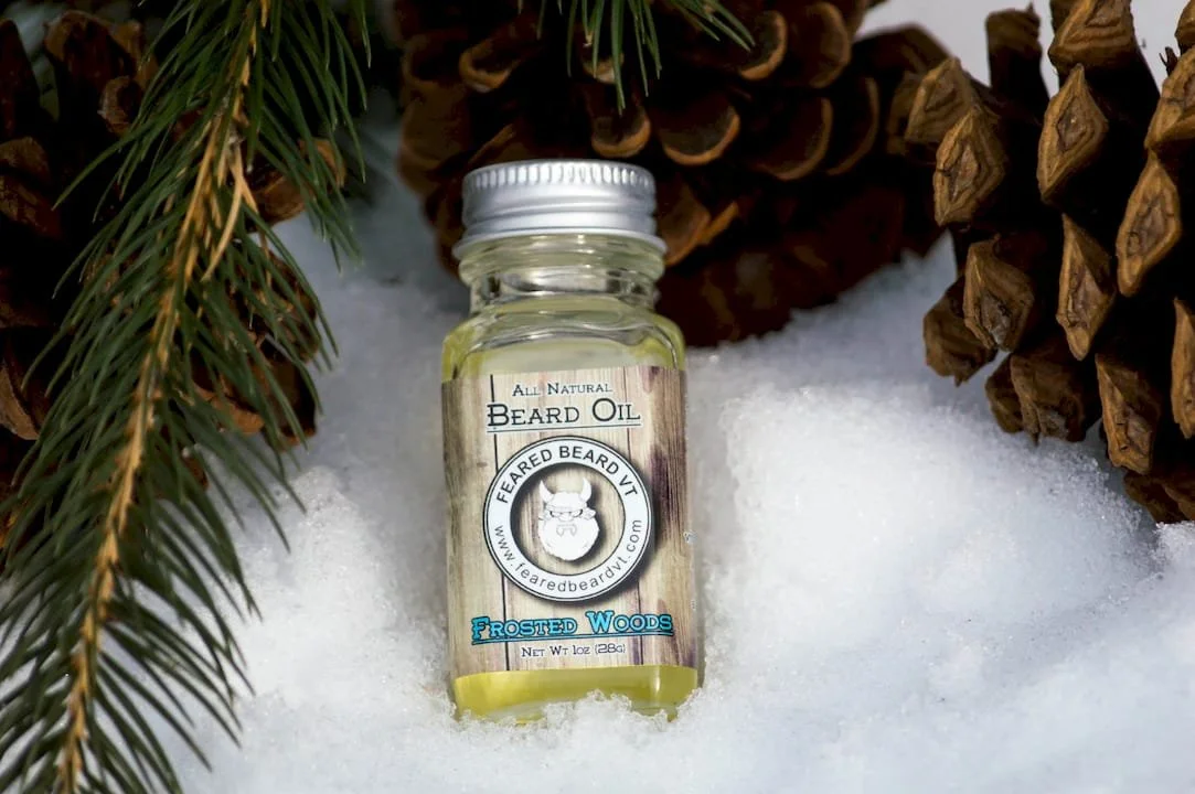 A frosted woods beard oil in snow