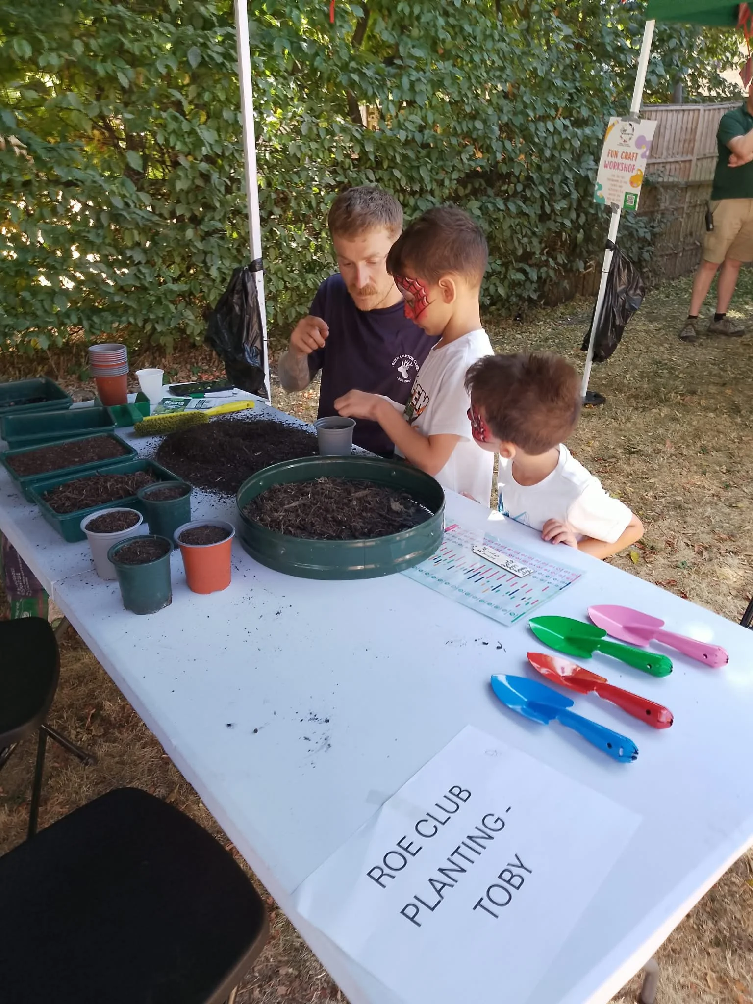 Some budding new gardeners learn from Toby the Gardener from Roehampton Club