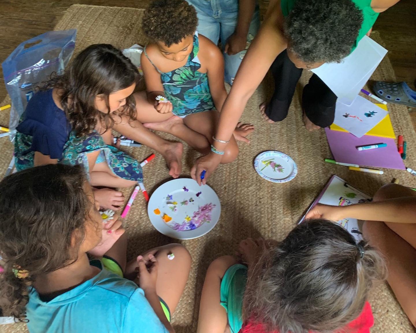 A group of beings connect with flowers