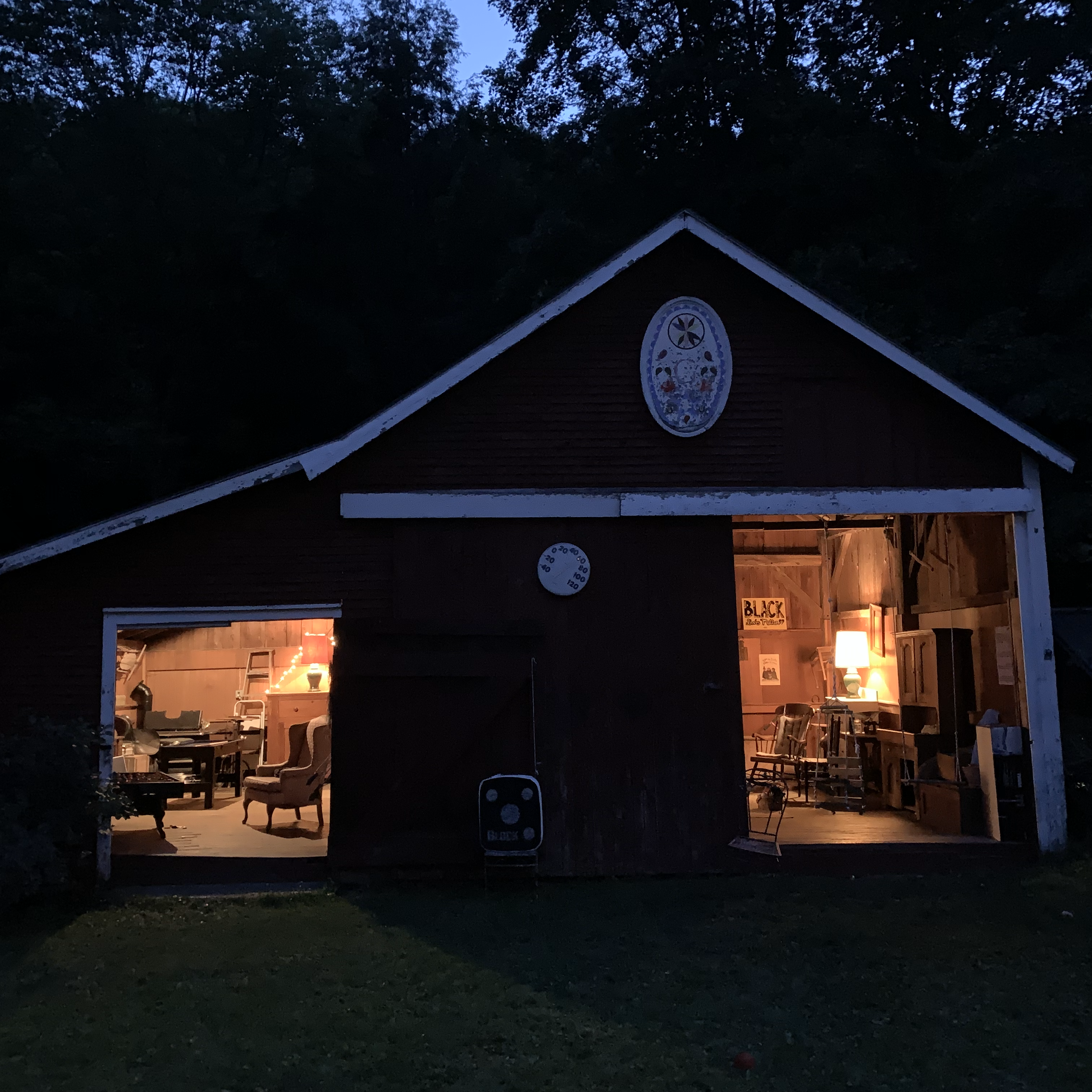Community space in the evening after the end of a gathering. Light comes from both open doors.