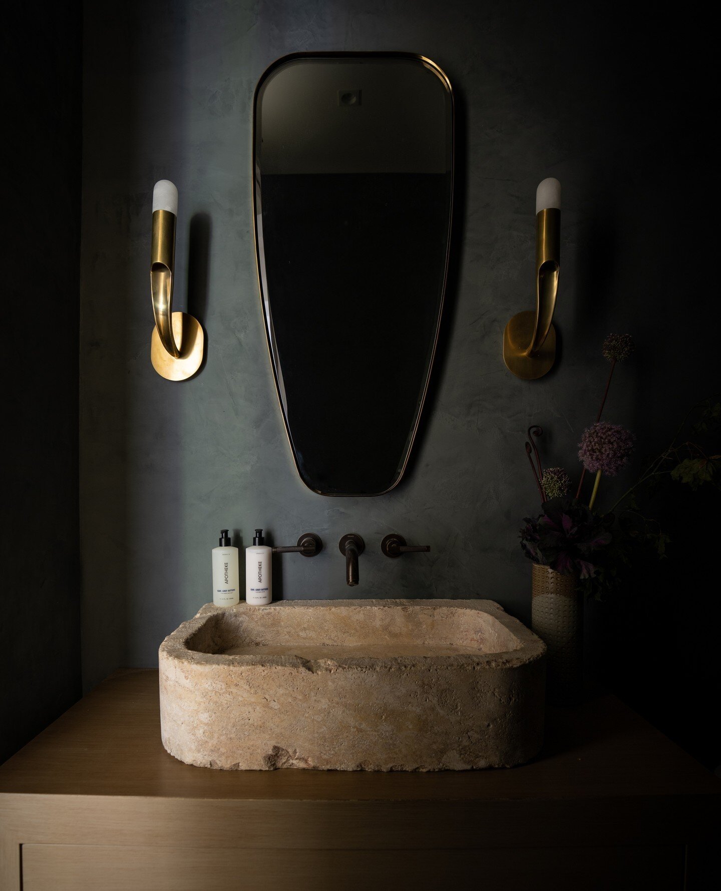 Smoke &amp; Mirrors.⁠
⁠
Welcome guests into this beautiful powder bath. Reflective surfaces set in a smoky setting accented by aged stone. The perfect juxtaposition of old and new.⁠
⁠
#laurabrophyinteriors