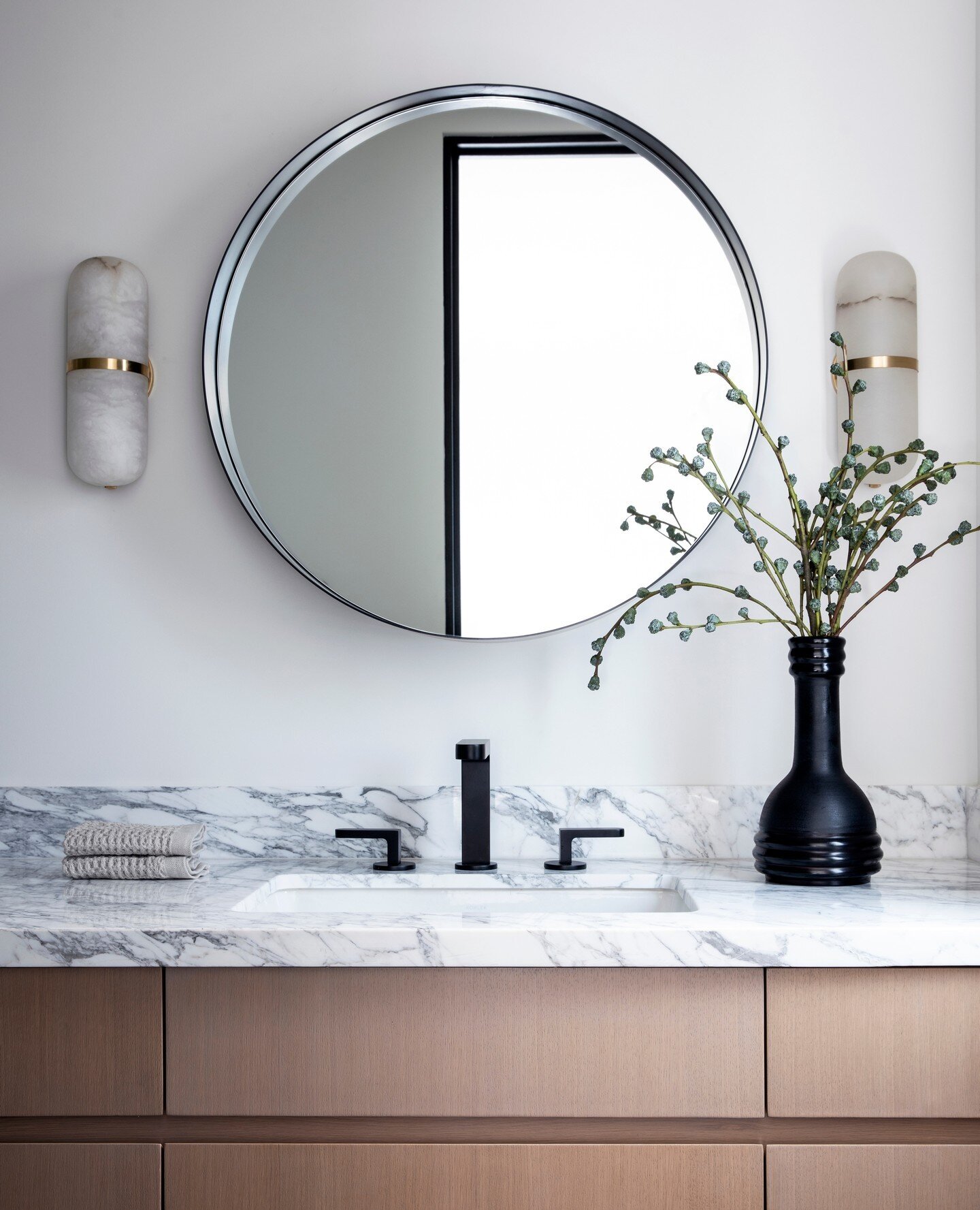 Simple doesn't mean boring. The light oak cabinetry contrasted by matte black hardware and marble countertop make this bathroom one of our favorites from our #222Second project.⁠
⁠
Visit brophyinteriors.com to explore the entire 222 Second project an