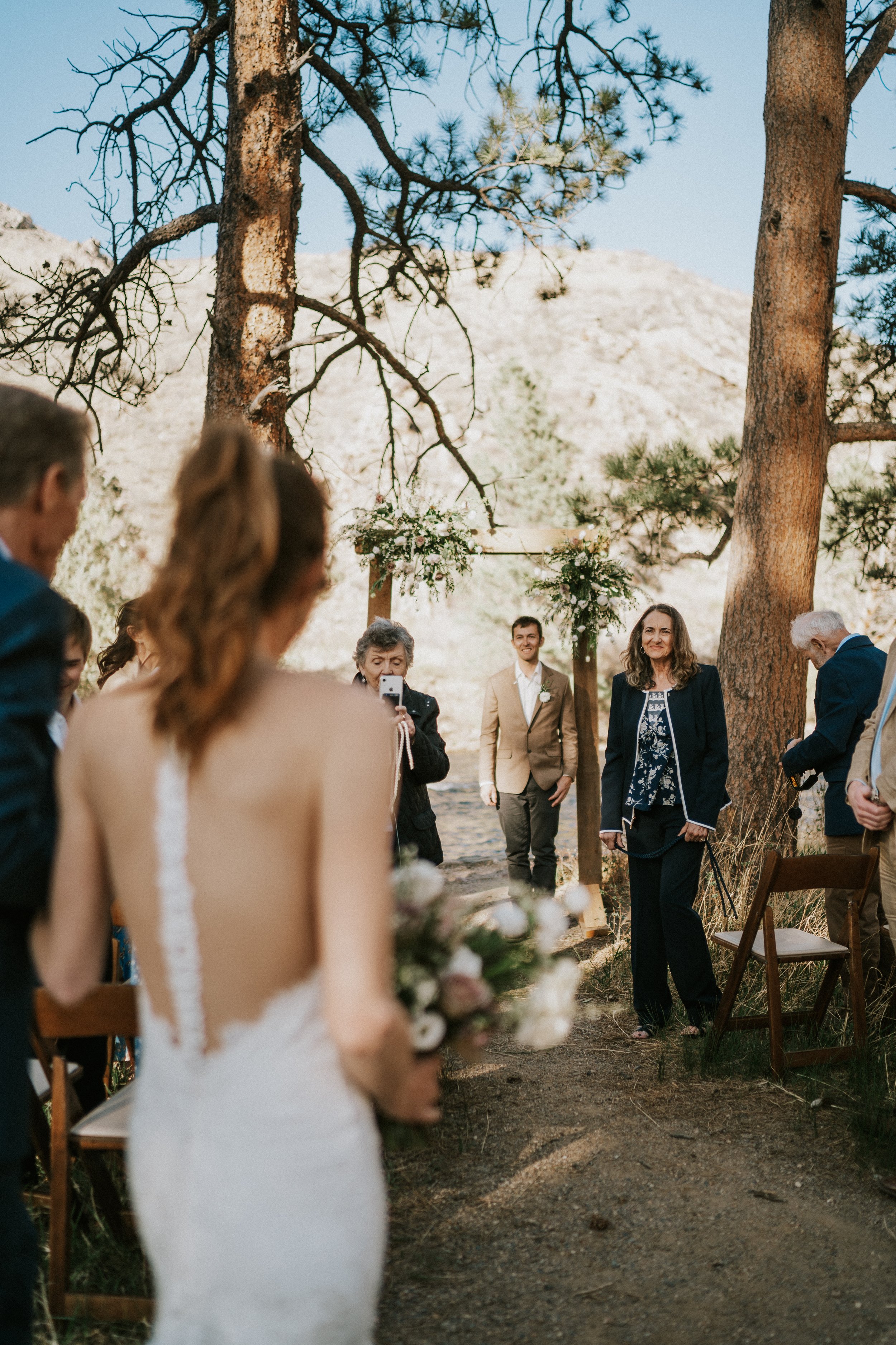 poudre-canyon-fort-collins-wedding-photographer-bride-walking-down-aisle